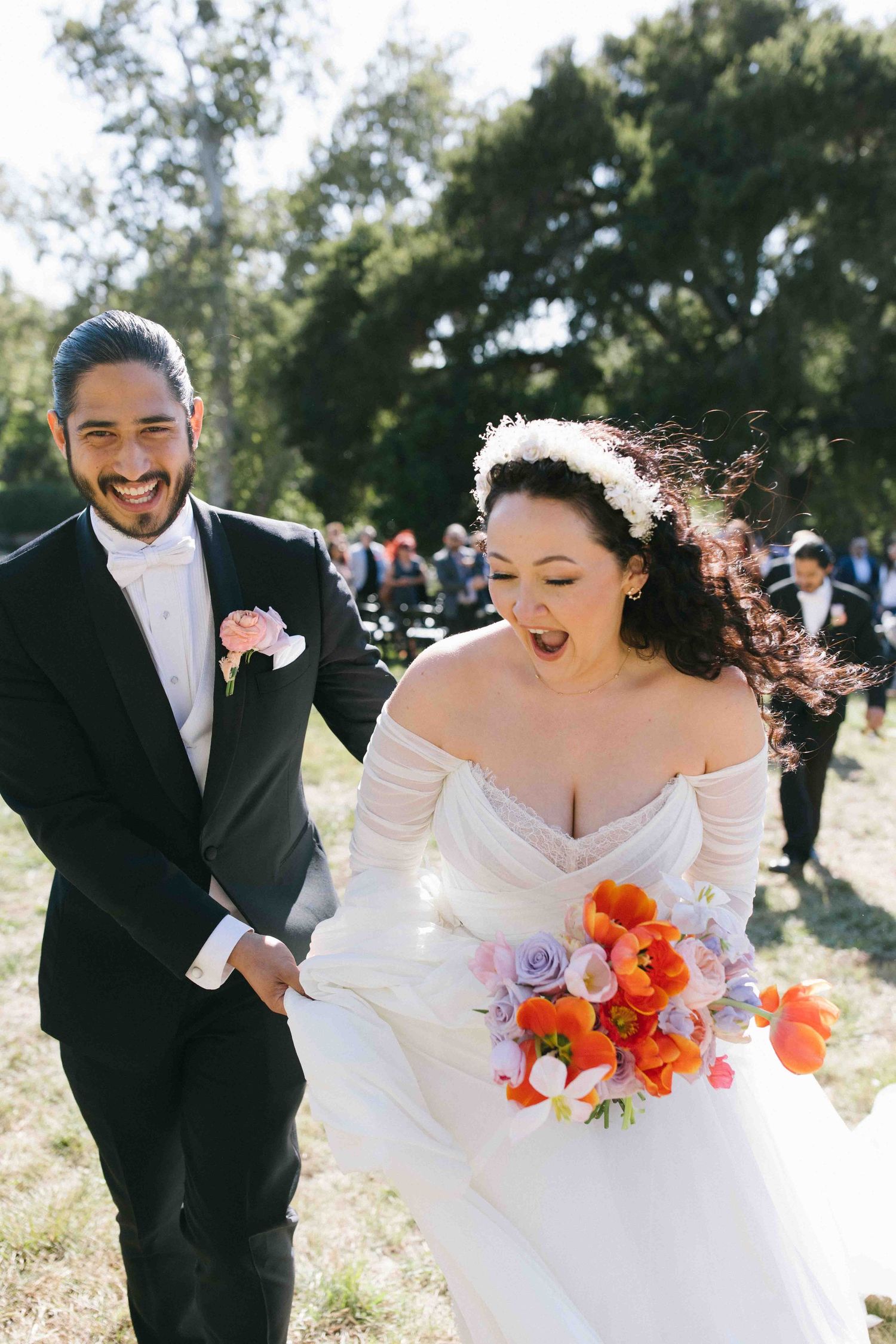 Joyful documentary moment of a newly married couple walking together down the isle