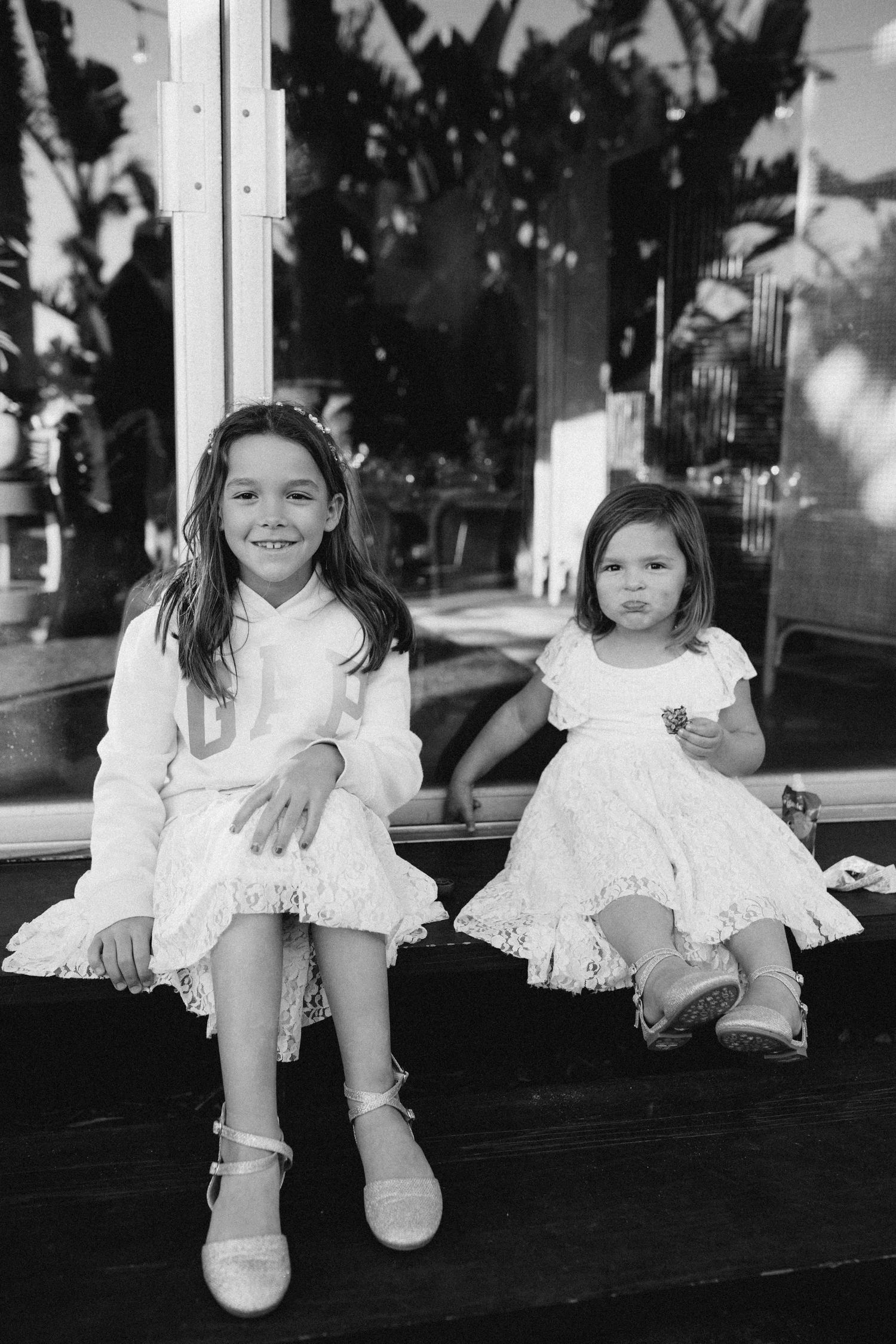 Candid moment of two children sitting together at a wedding