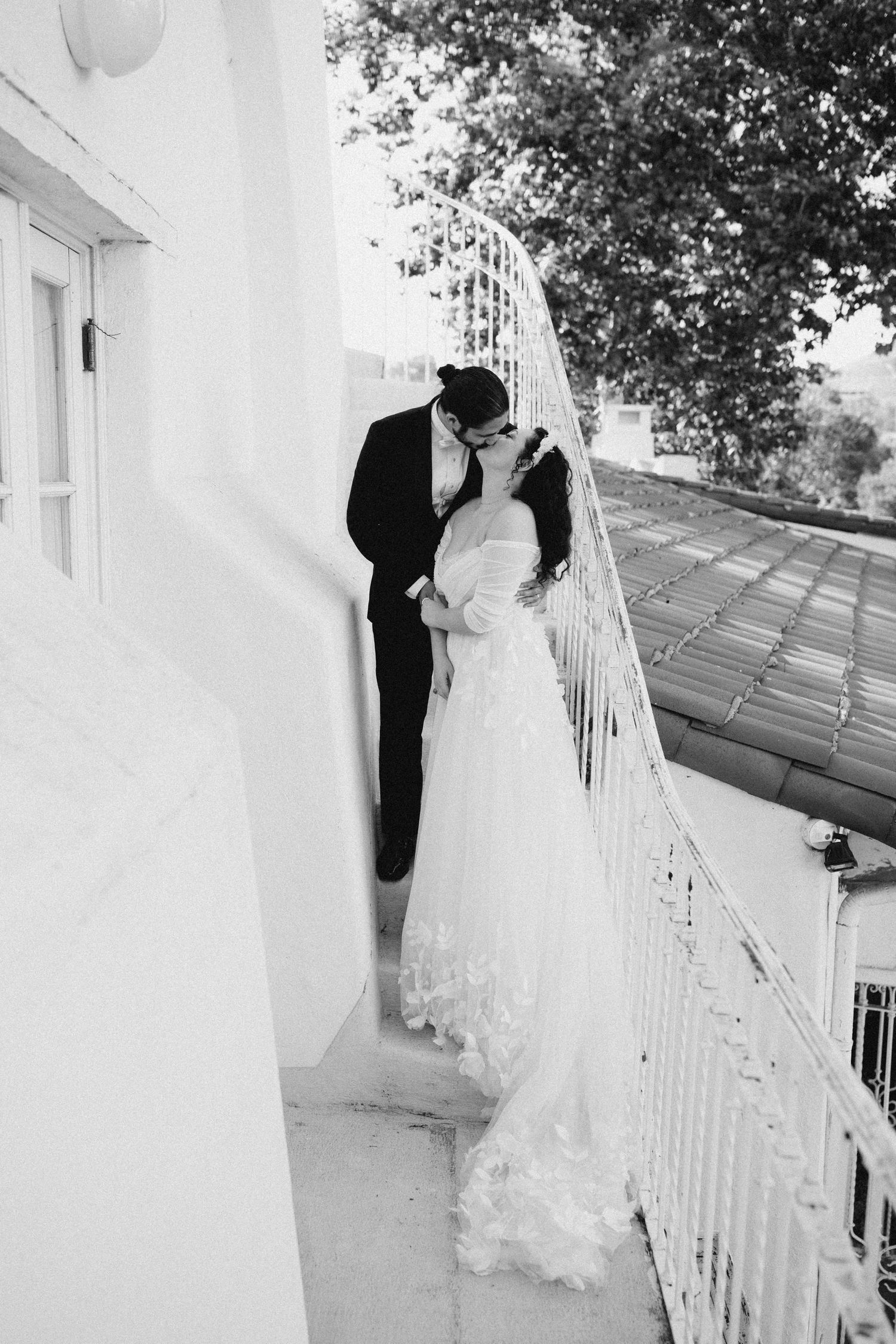Intimate moment of a bride and groom embracing outside their venue
