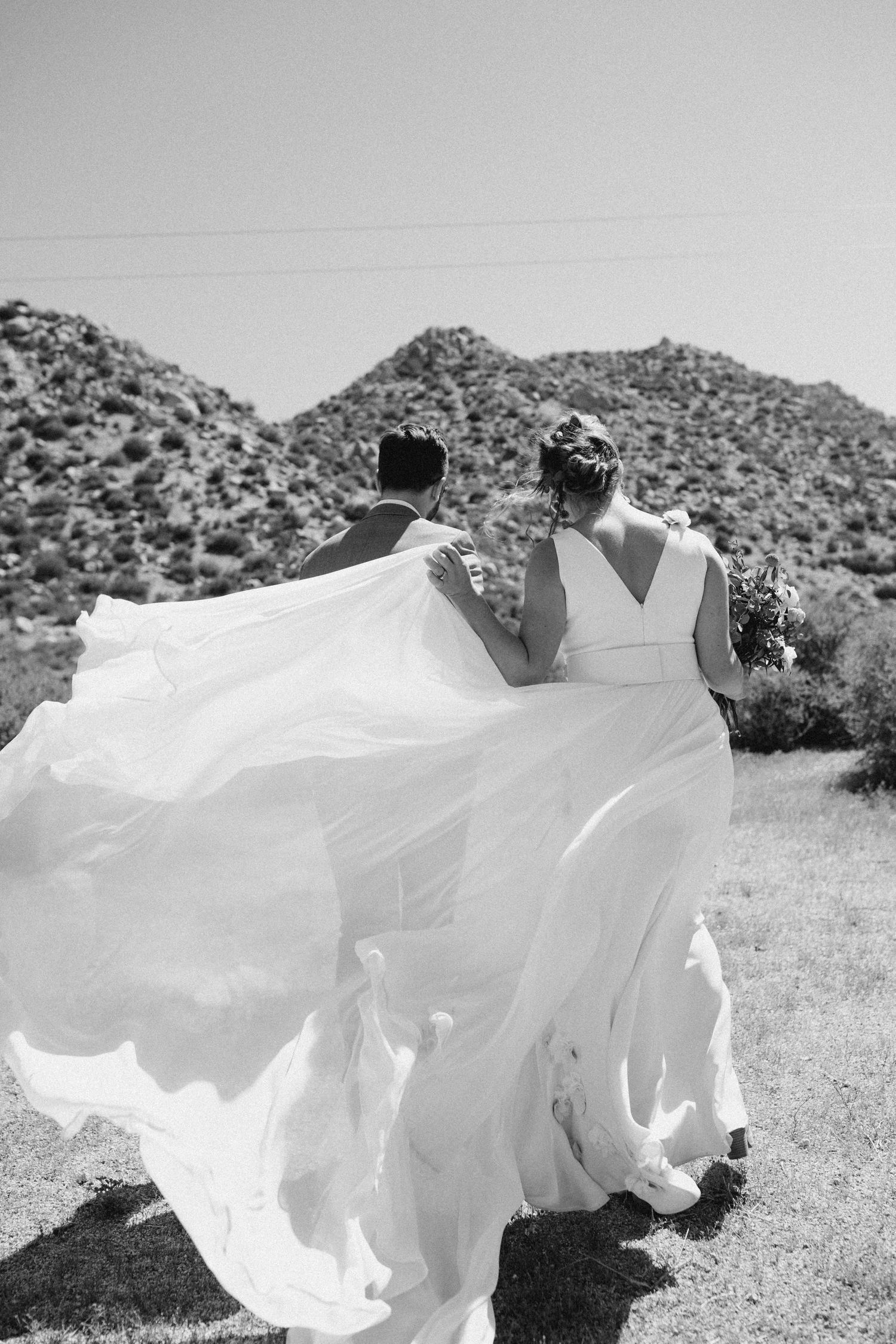 Documentary wedding portrait with flowing veil in an outdoor setting