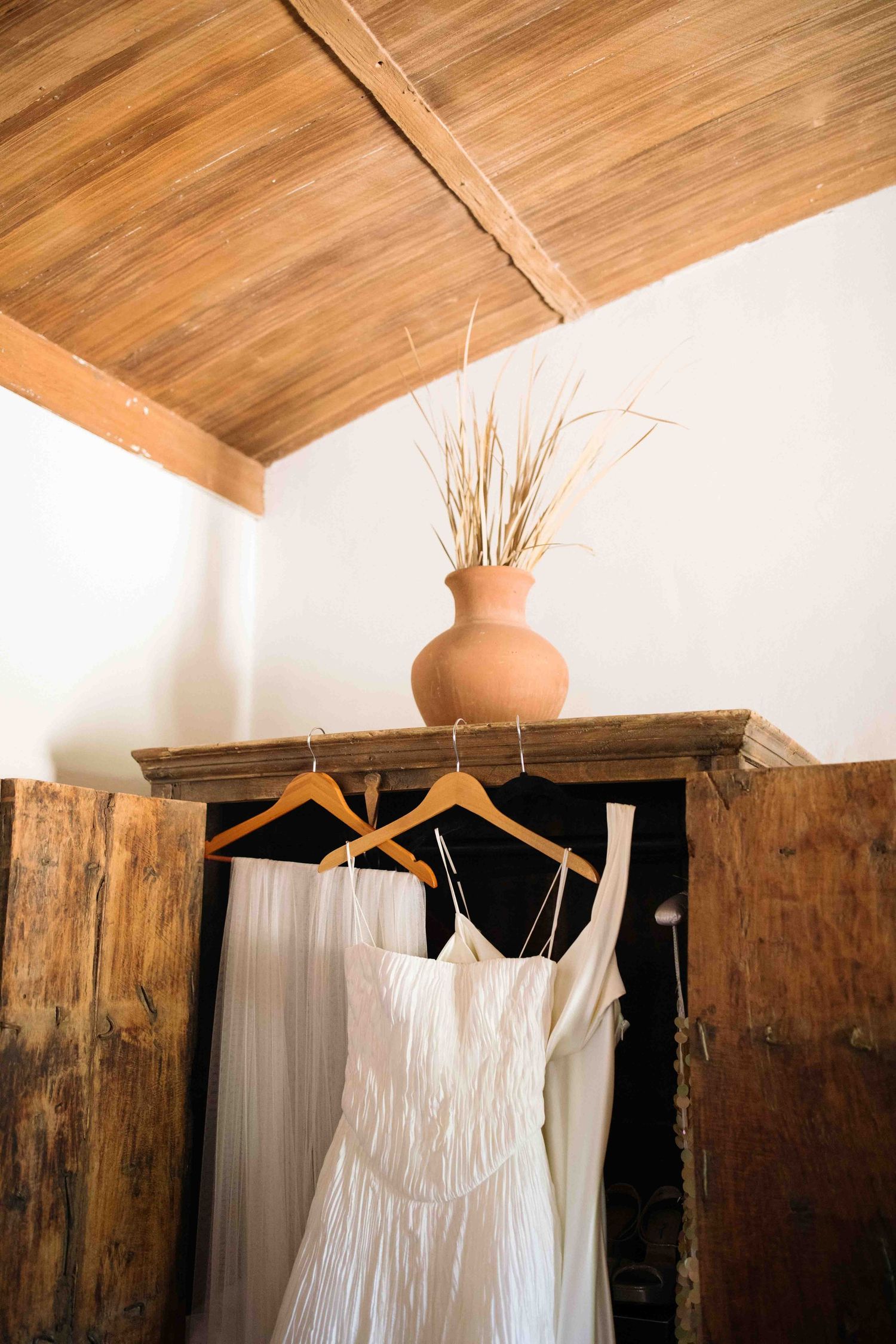 Wedding dress hanging in natural light before the ceremony