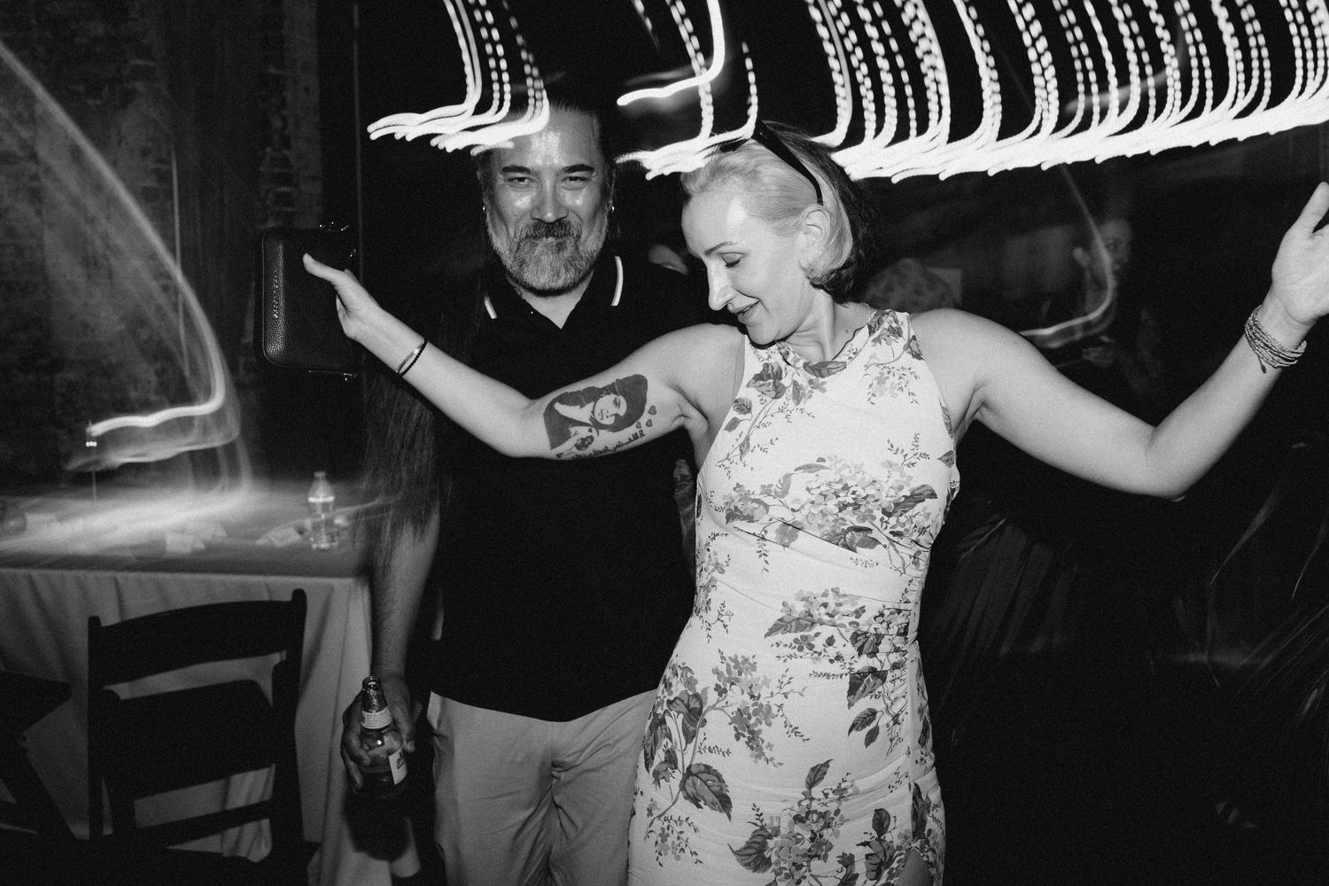 Joyful documentary wedding reception moment with guests dancing