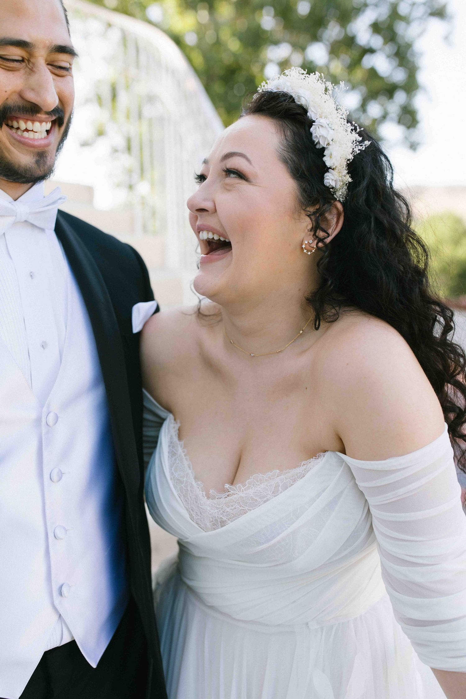 Unscripted moment of a bride laughing with her partner during their wedding