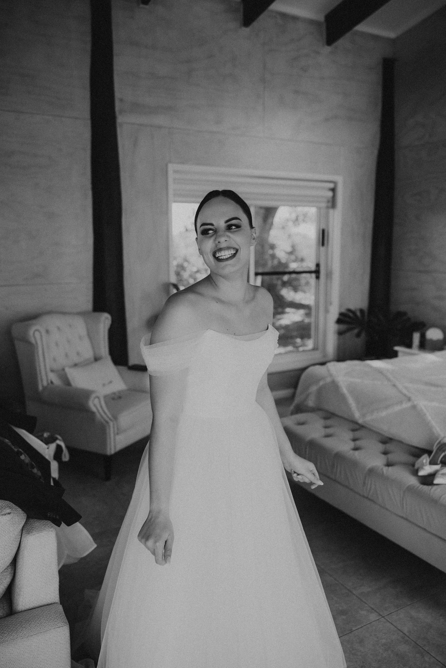 Black and white images of someone in a wedding dress getting ready in a room.