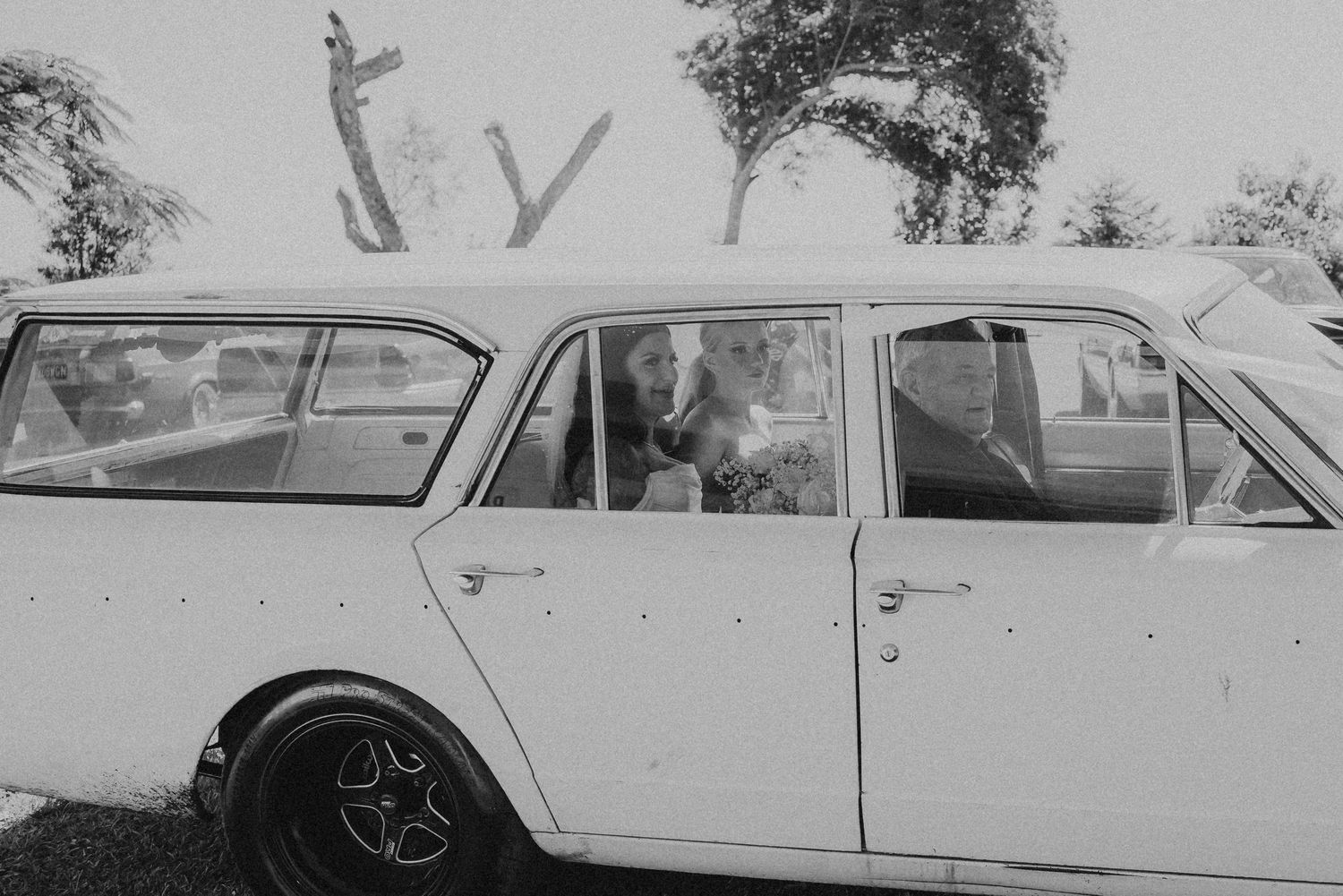 Classic vintage cars lined up in black and white photography at a retro automotive gathering.