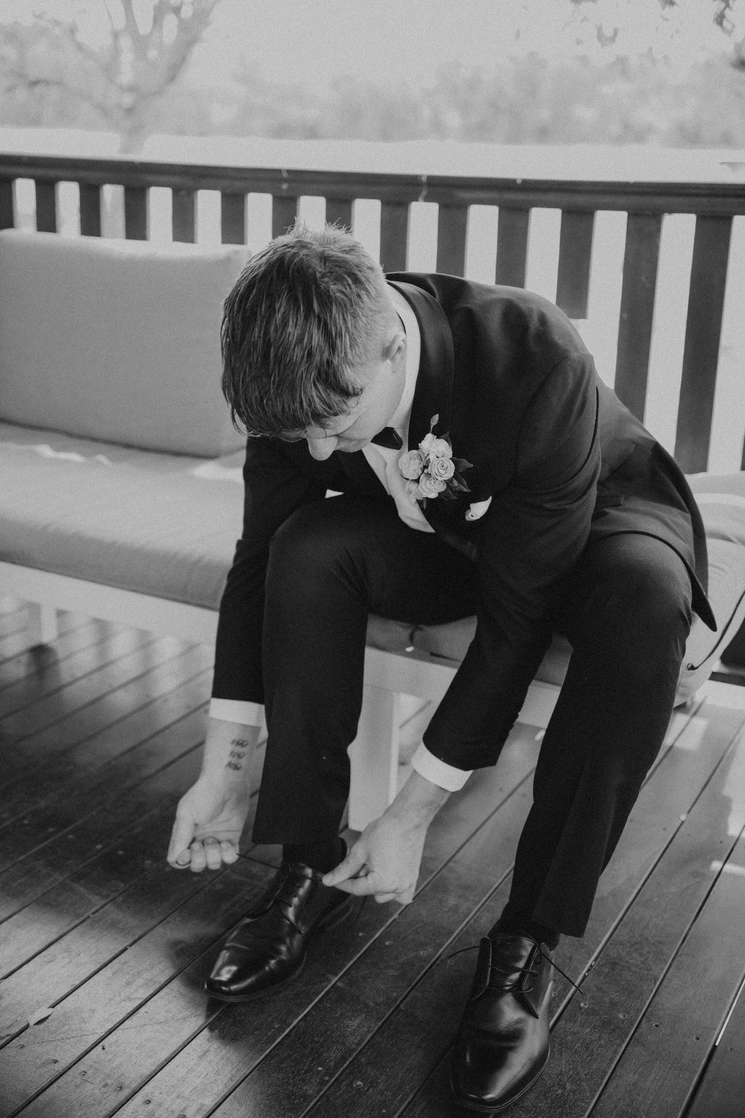 Black and white photos showing formal shoes and attire on wooden deck.