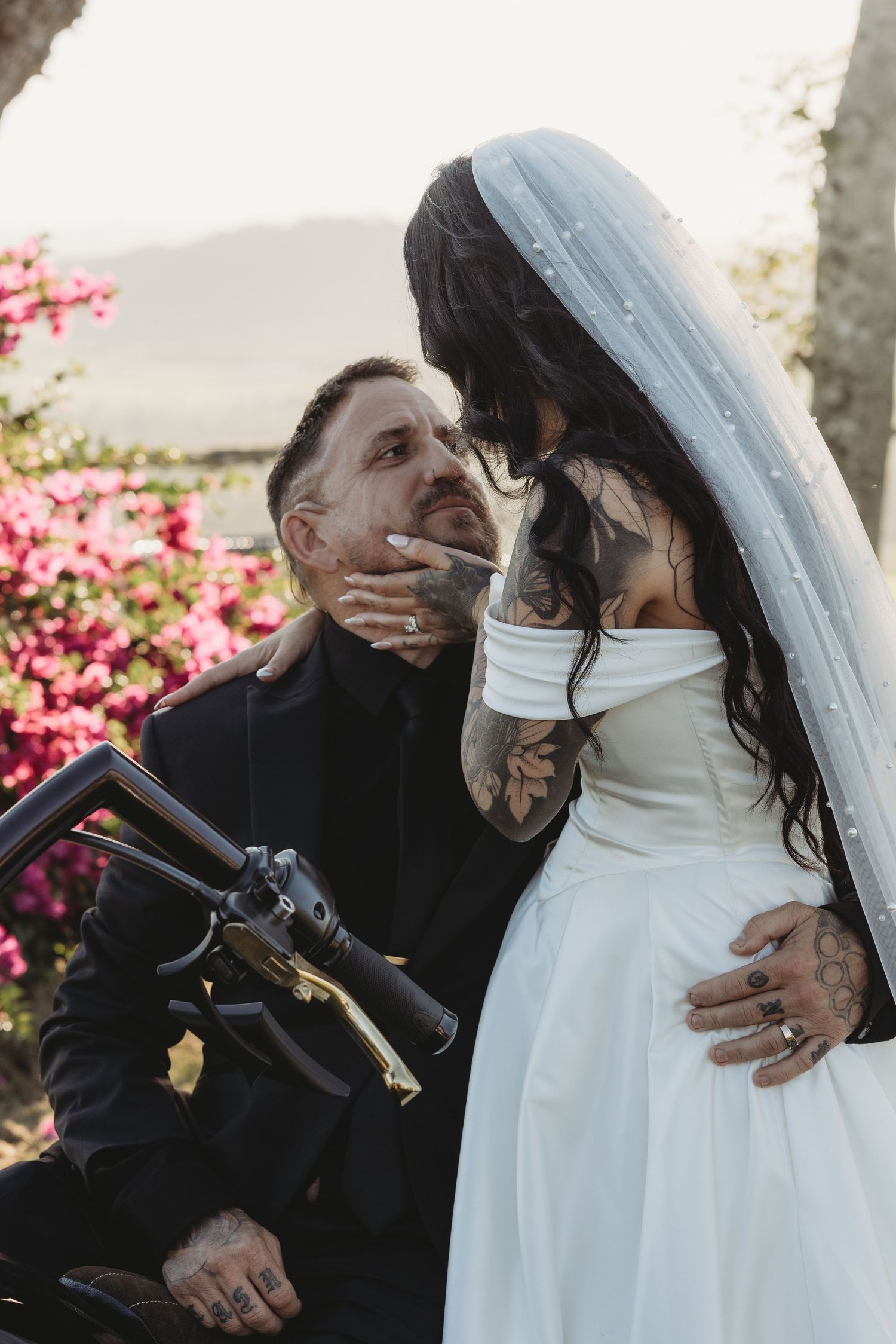 A romantic wedding moment captured in a series of photos with pink bougainvillea flowers in the background.