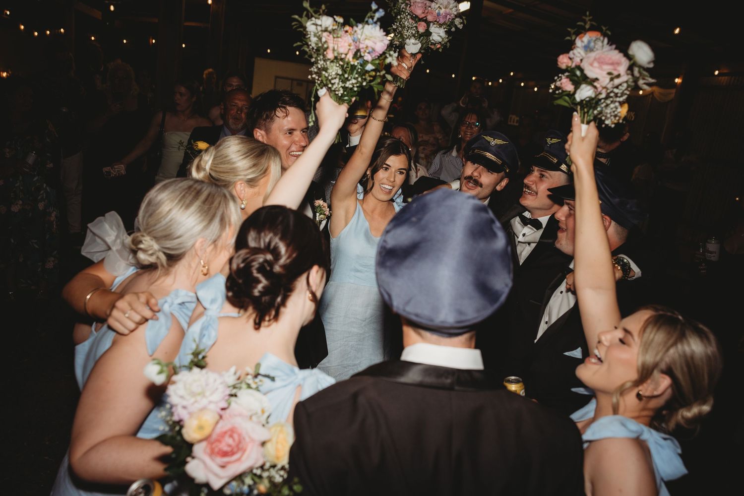 Energetic wedding reception dancing with guests enjoying the celebration.