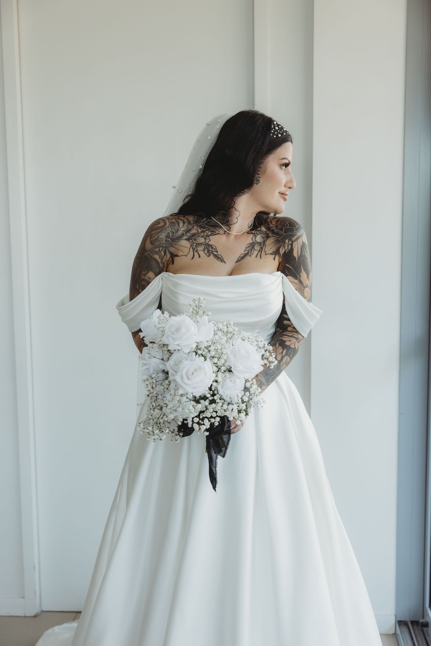 A flowing white wedding dress with floral details is showcased in multiple angles against a light backdrop.