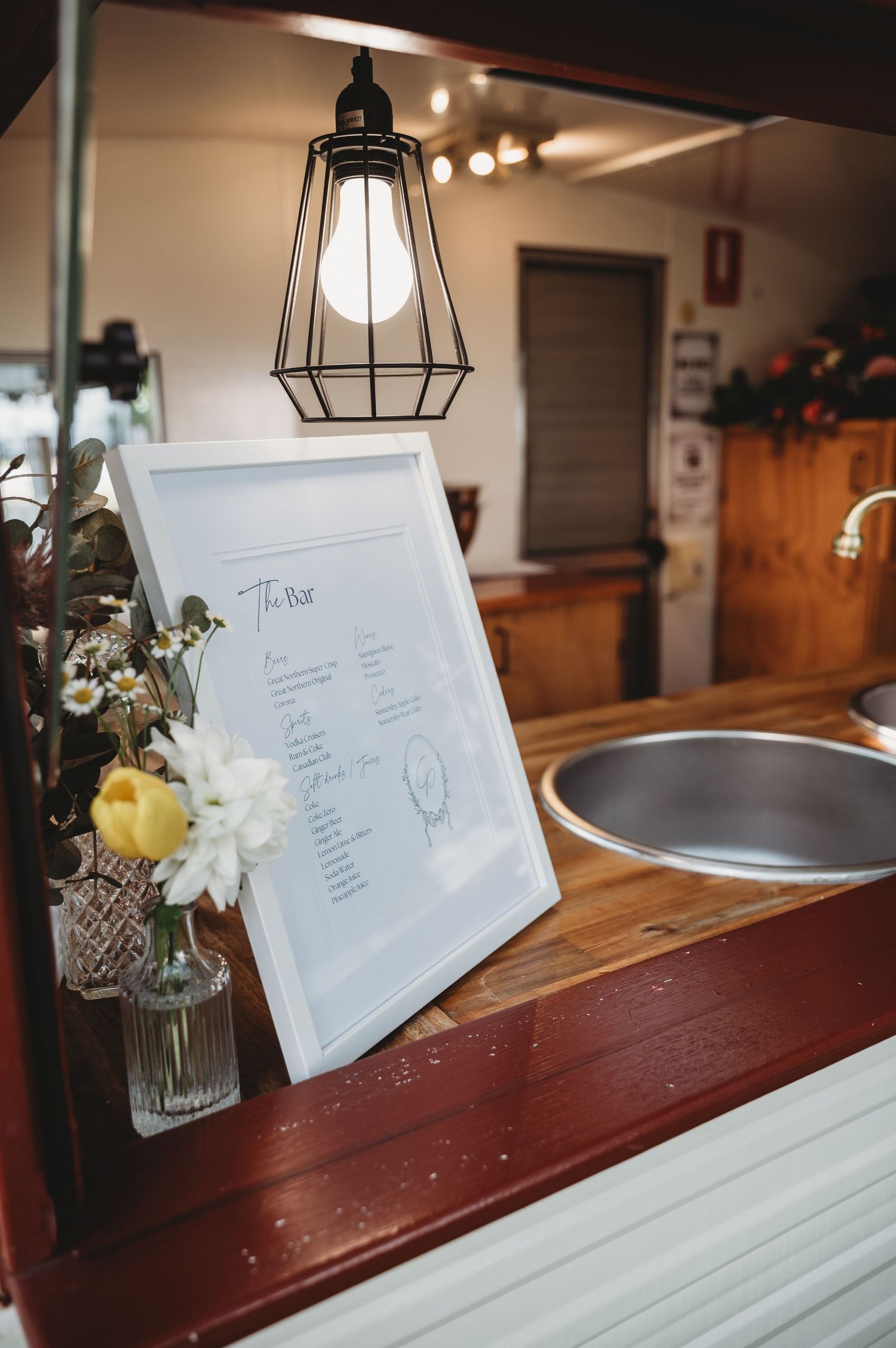 Wedding reception details with menu cards and floral accents on rustic wooden surfaces St Aubins Weddings
