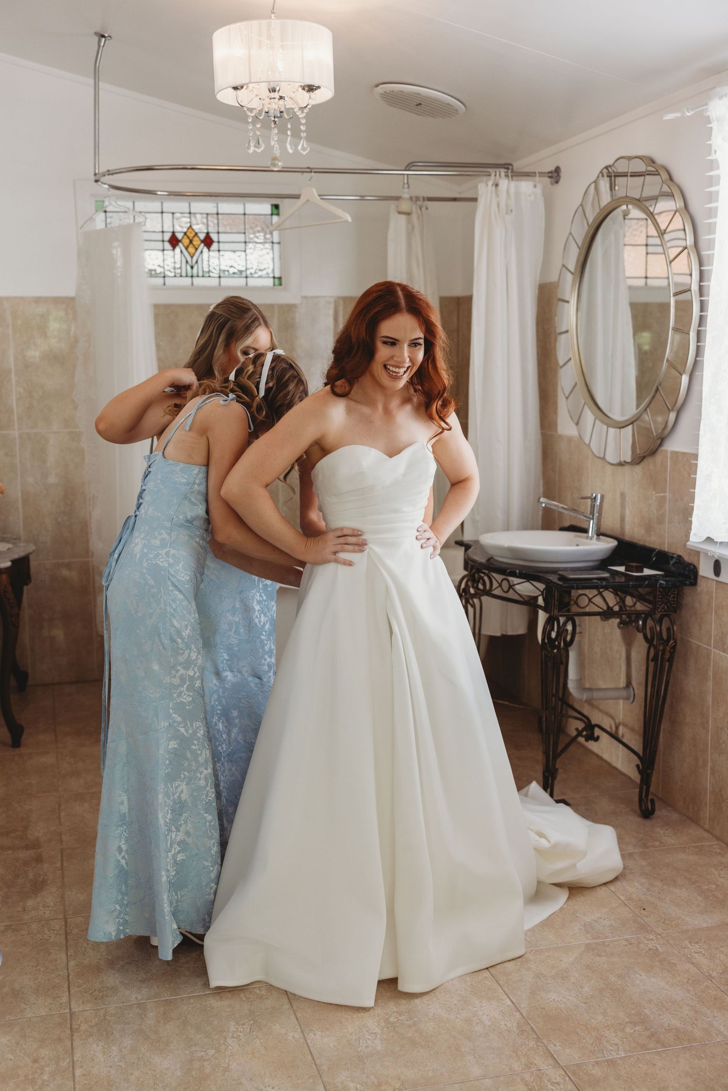 bridesmaids helping bride into dress emotional wedding moment St Aubins Rockhampton Wedding