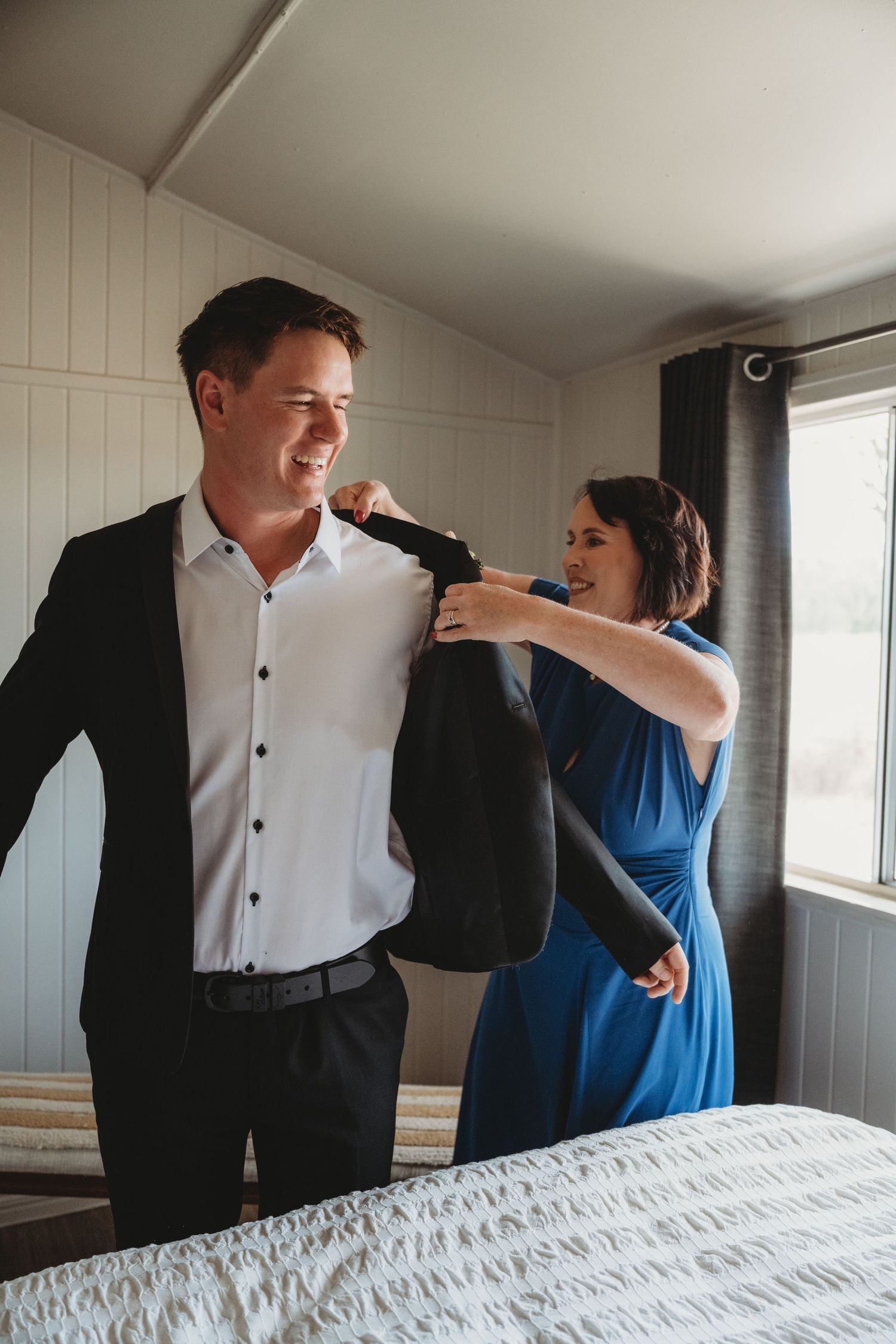 Wedding day moments captured in a sequence of casual interactions in a bright room.