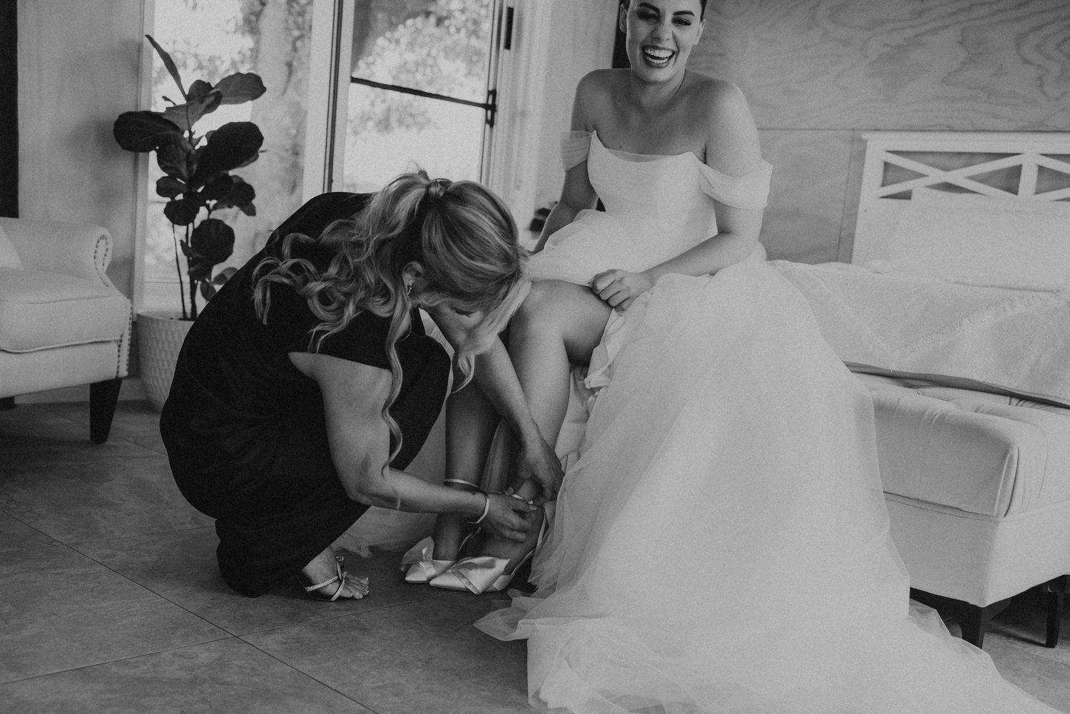 Black and white candid shots of wedding day preparations in a bridal suite.