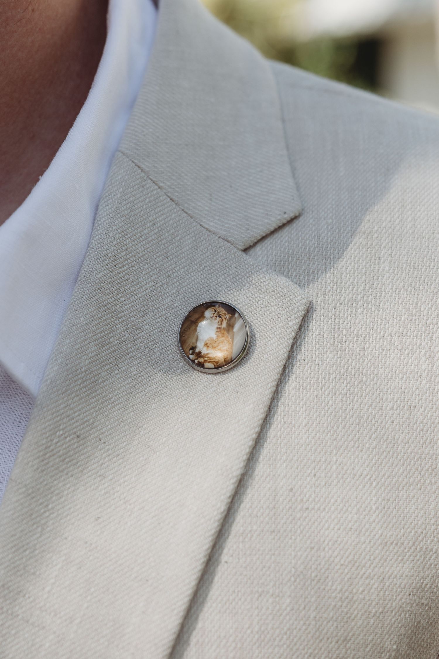 Close-up sequence showing a delicate pearl earring being placed through a white fabric.