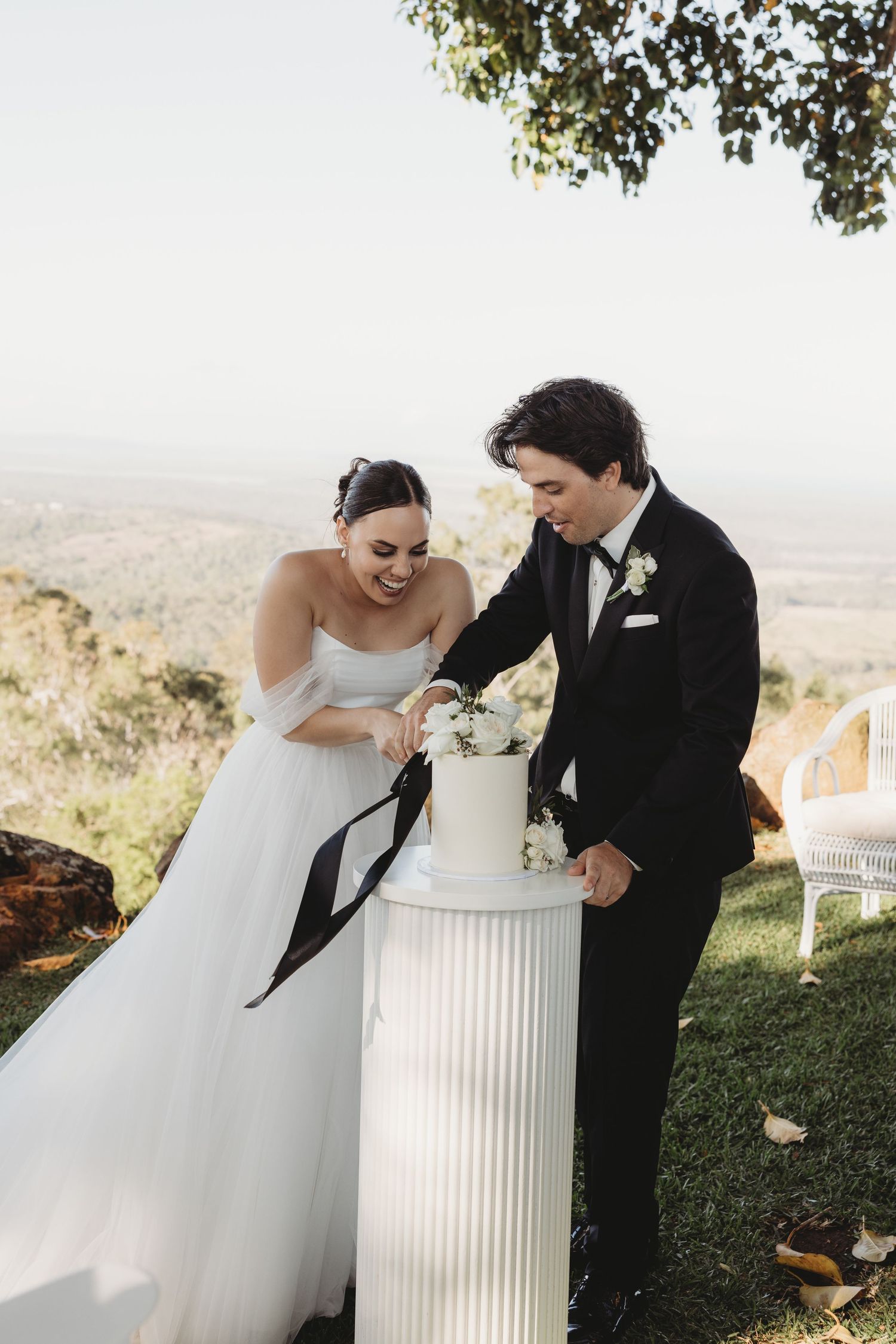 Couple shares a playful moment during their wedding cake cutting ceremony.
