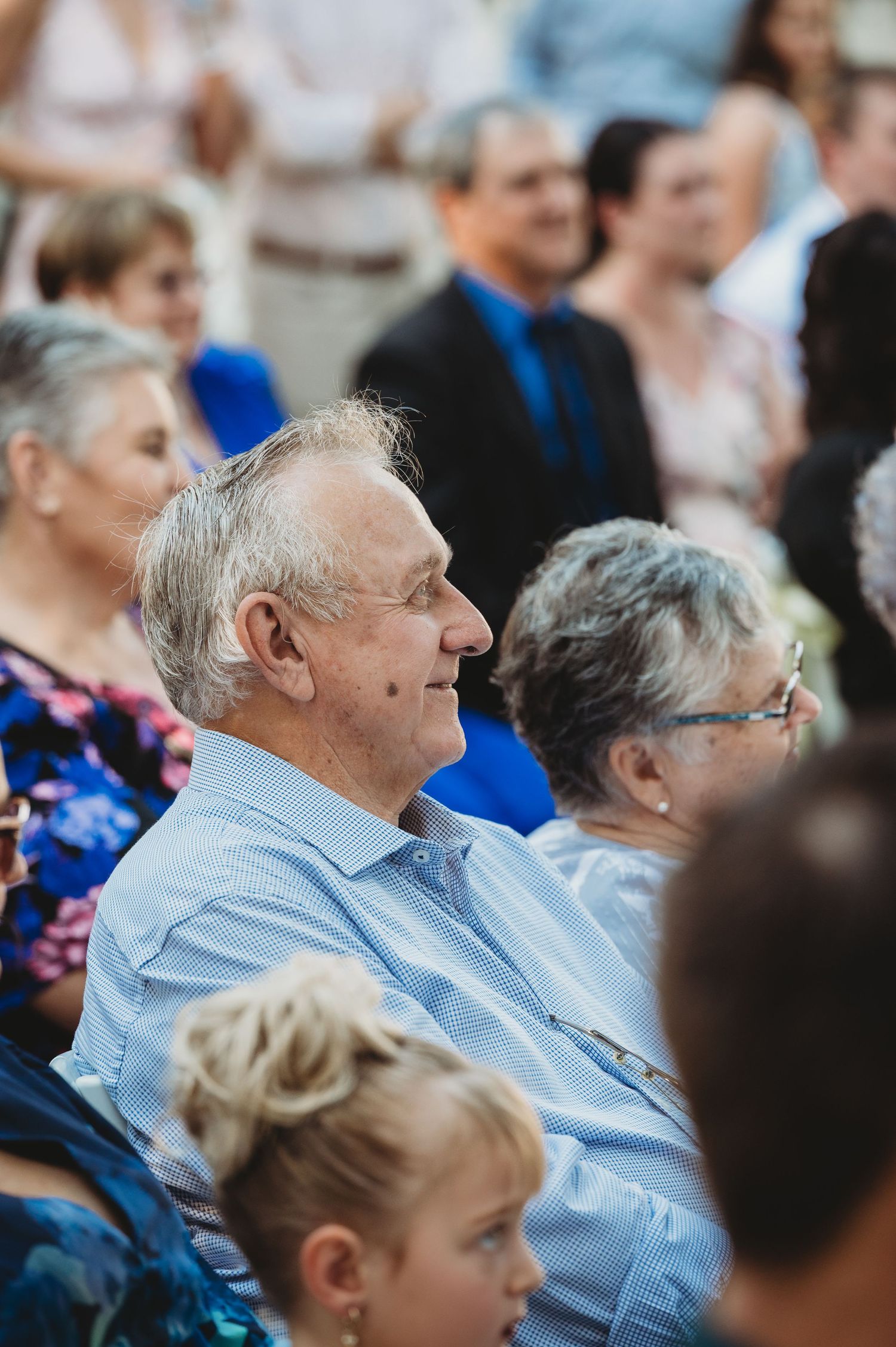 Wedding guests seated outdoors watching the ceremony with joyful expressions Central Queensland Wedding