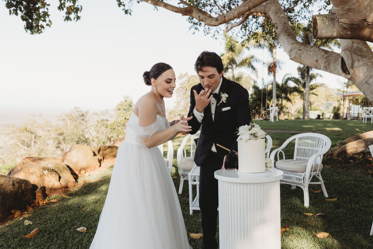 Newlyweds share intimate moments during their outdoor wedding reception.