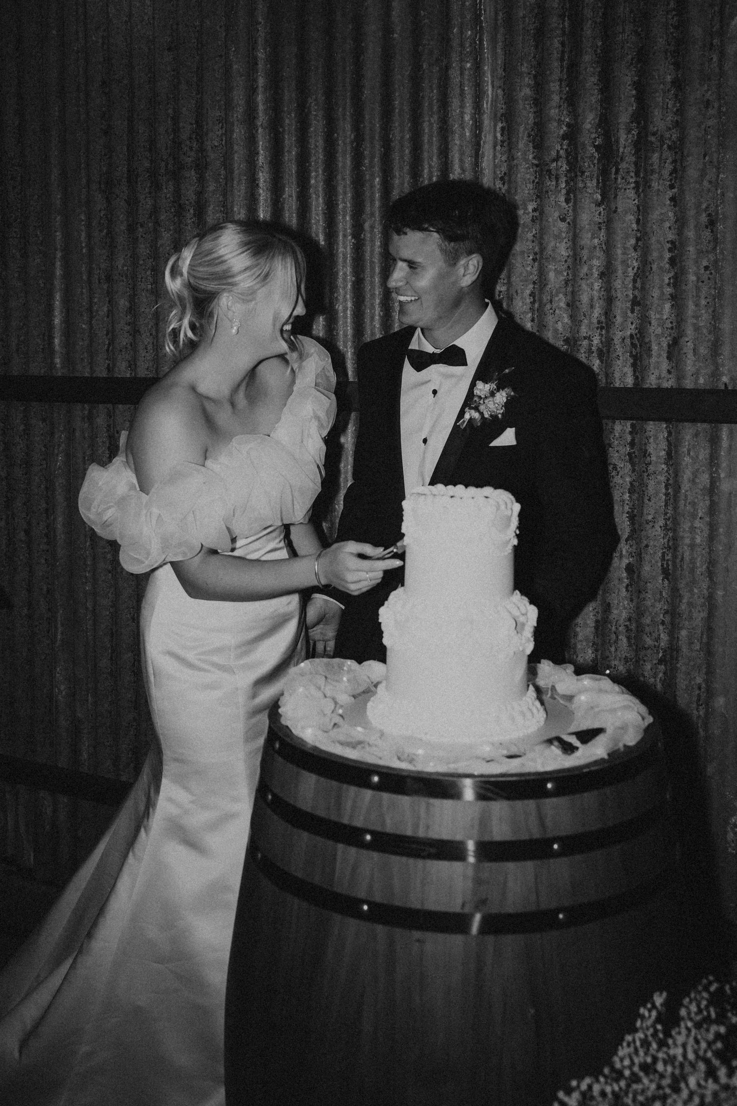 Black and white photo sequence of newlyweds cutting their wedding cake together.