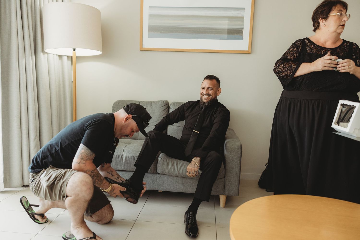 Series of playful behind-the-scenes moments from a wedding preparation showing someone in black attire on the floor.