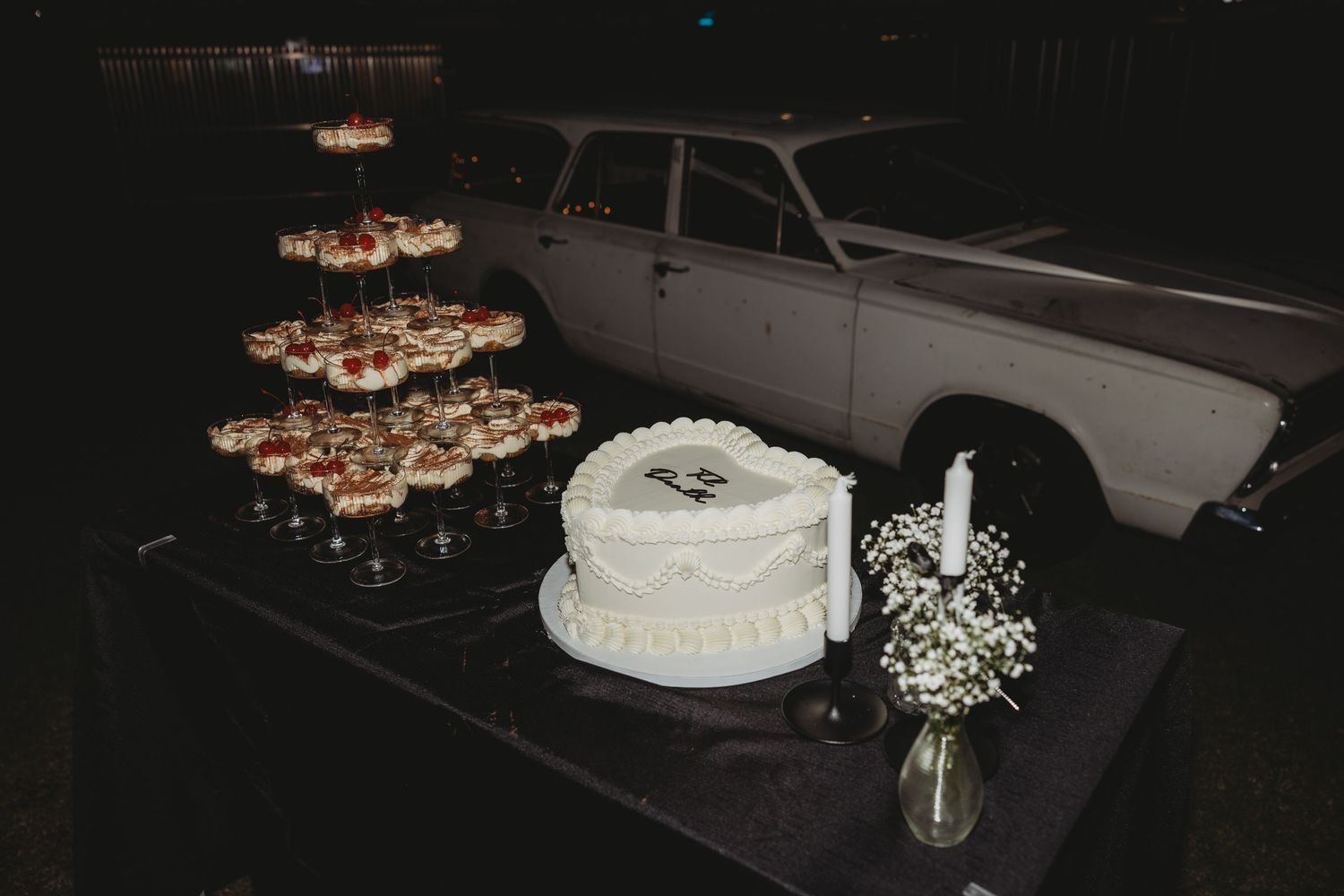 Reception tables decorated with floating candles and ambient lighting at night.