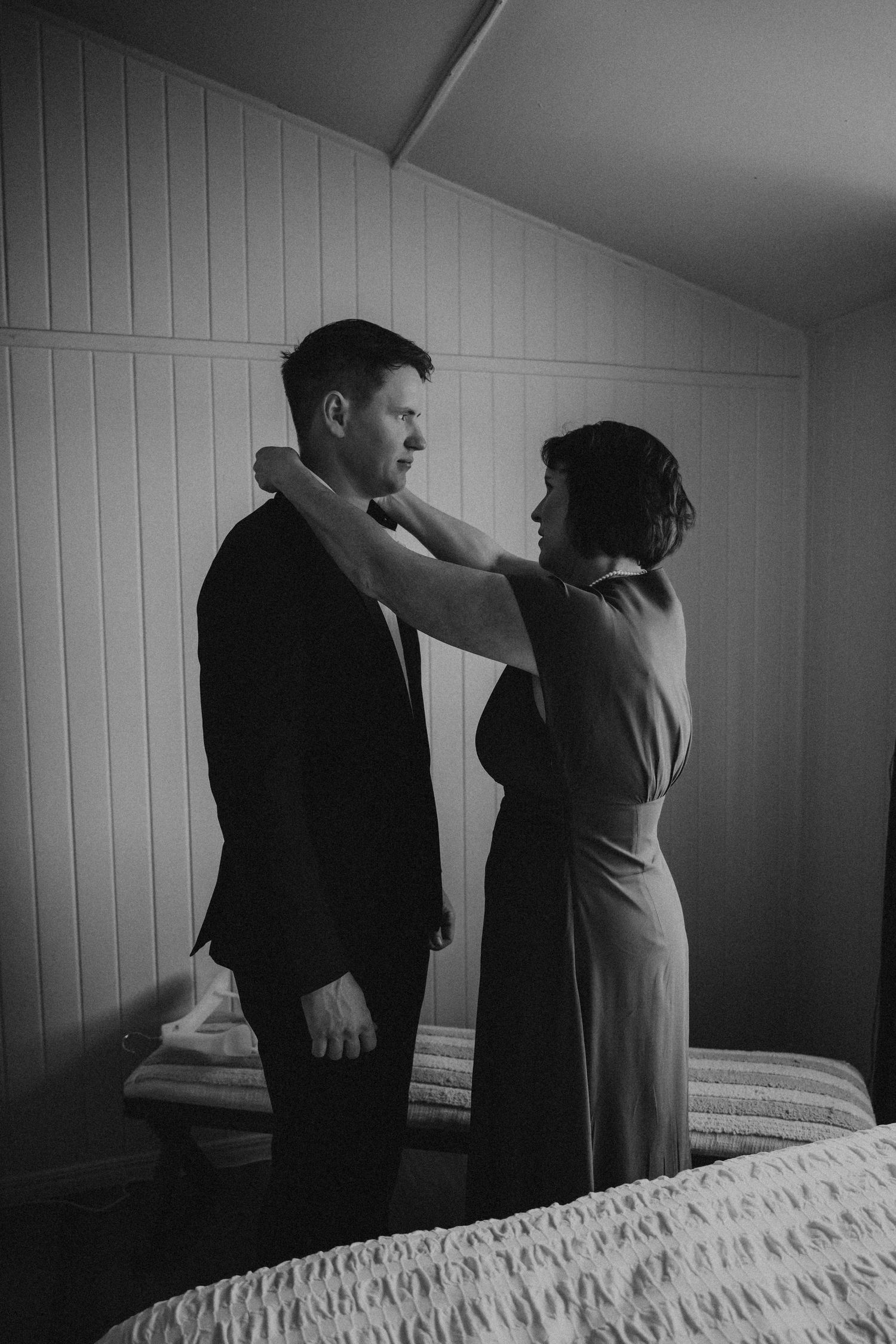 Black and white sequence of wedding preparations in a minimalist room setting.