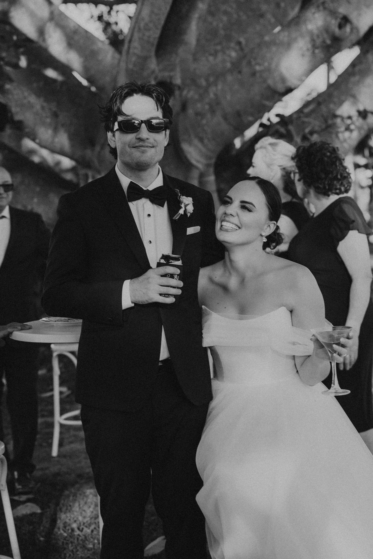 Black and white photo of an elegant outdoor wedding celebration.