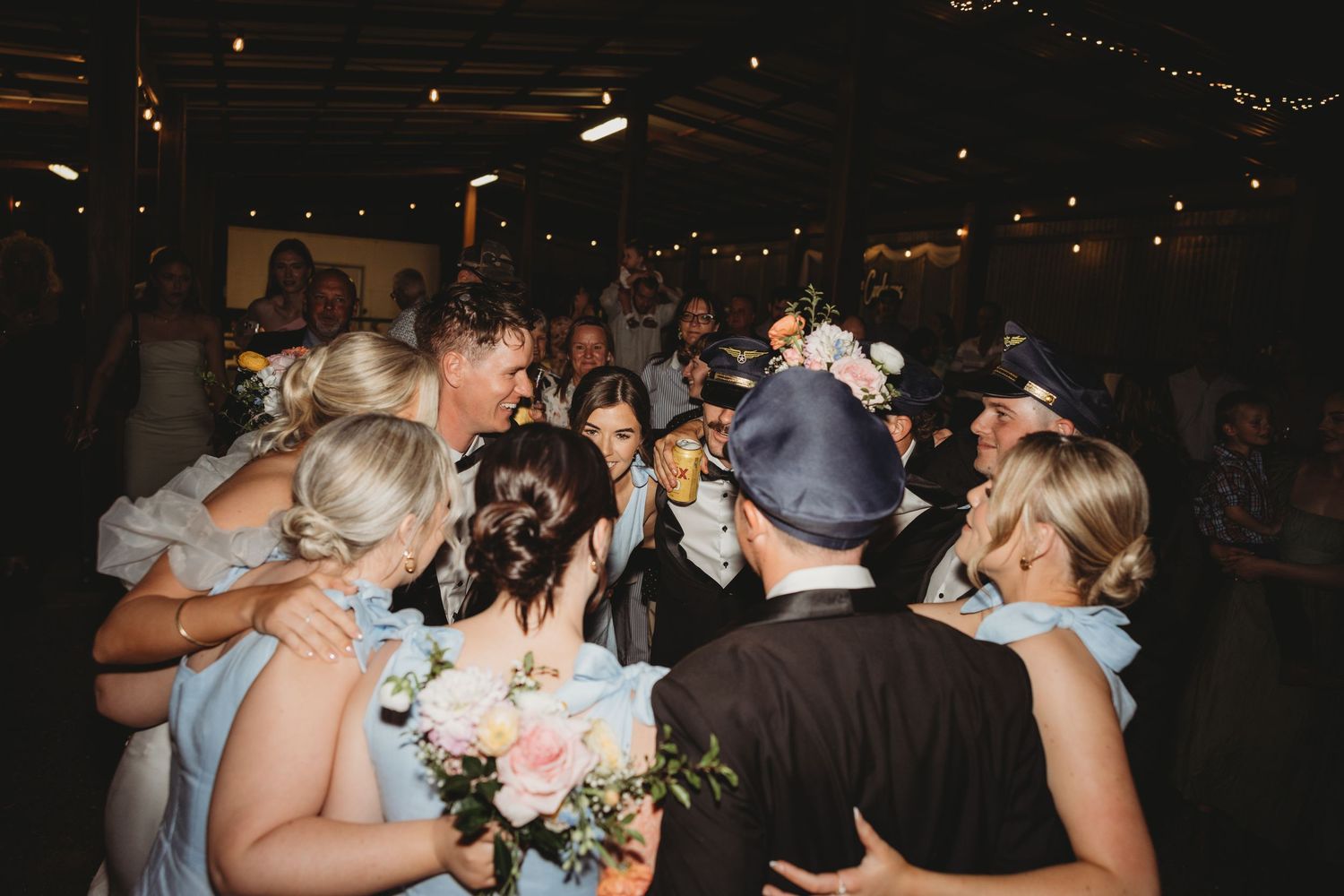 Lively dance floor moments captured during wedding reception celebrations.