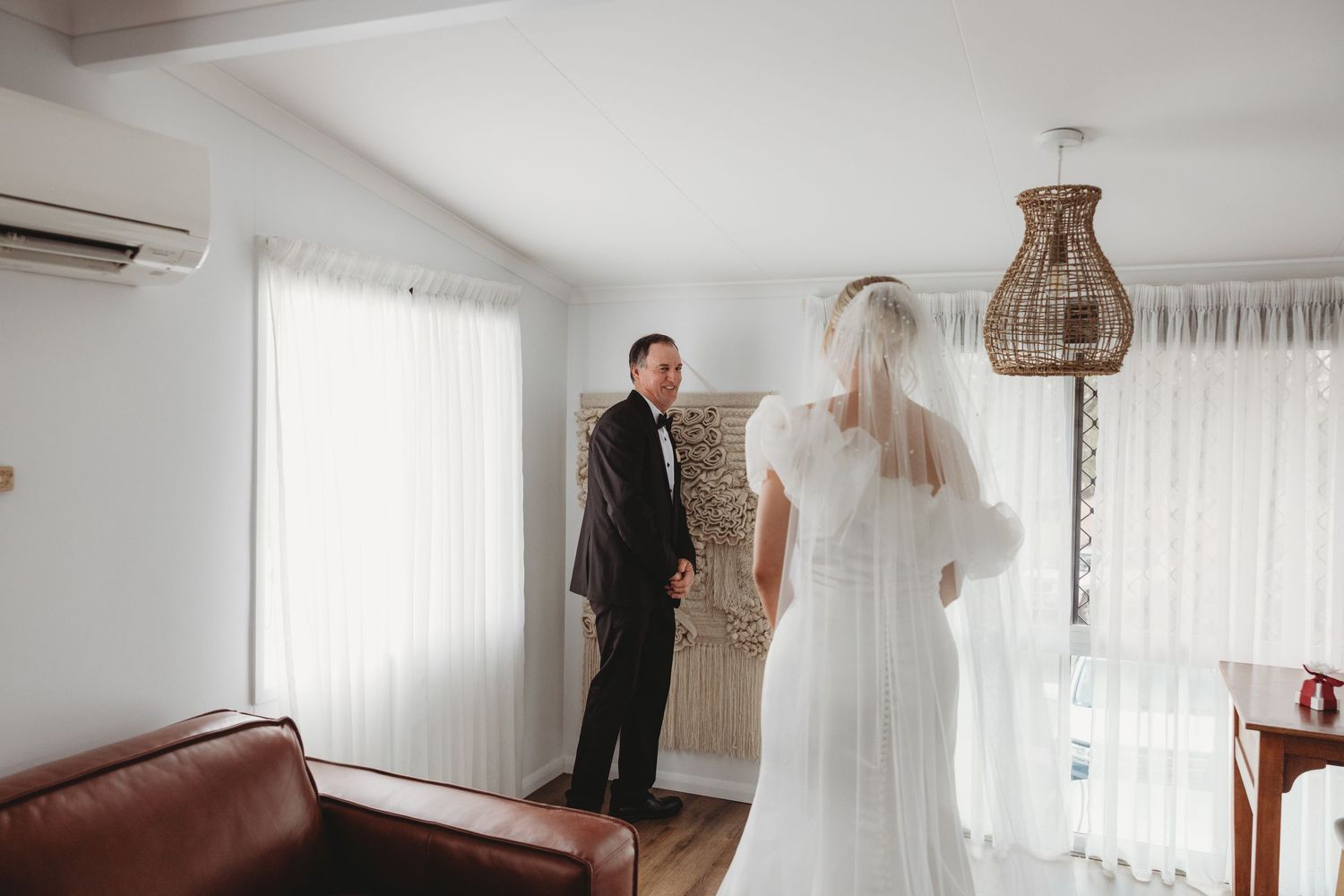 Wedding preparation scene in modern room with natural lighting and minimal decor.