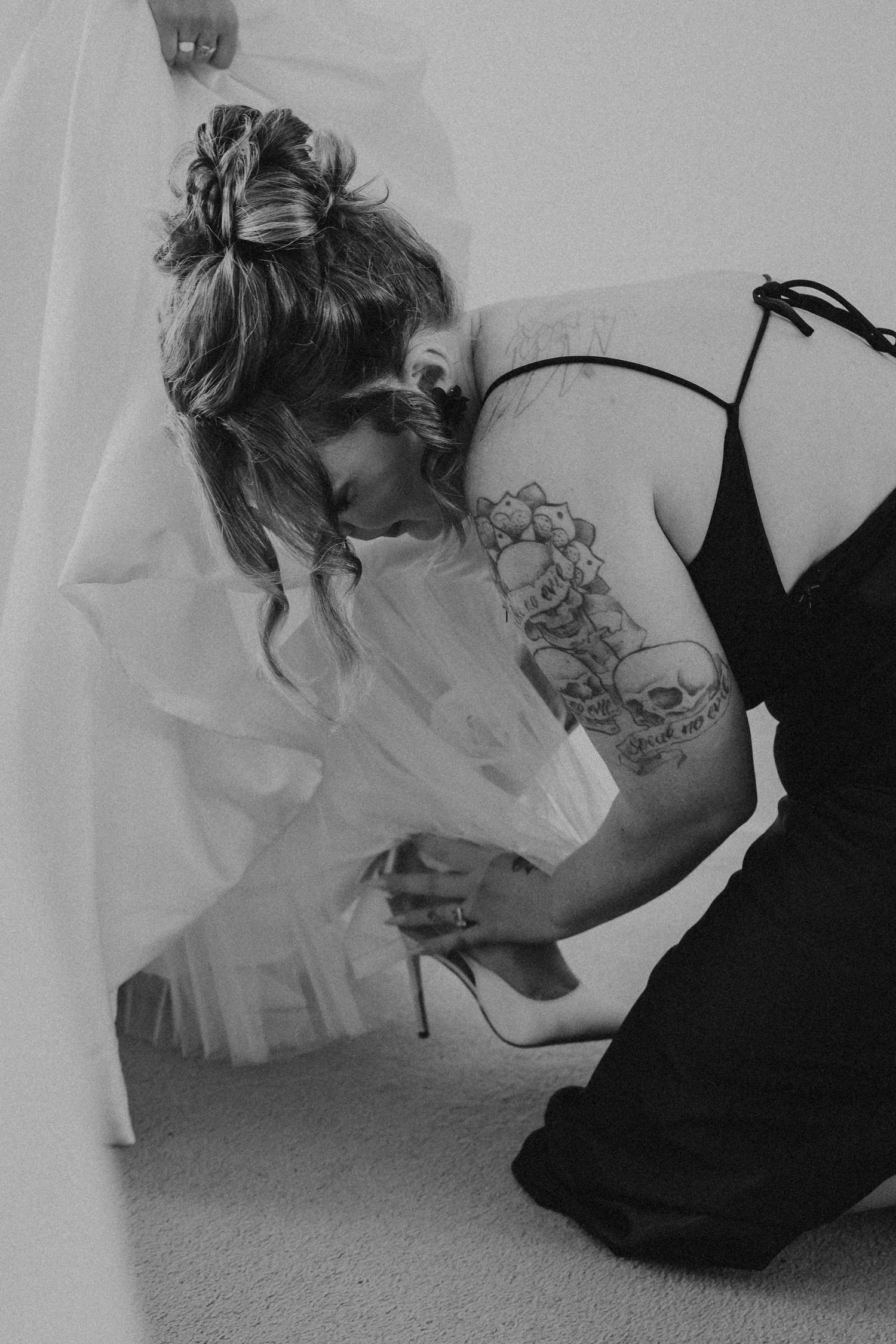 A series of black and white photos showing someone in a dress crouching down on a carpeted floor.