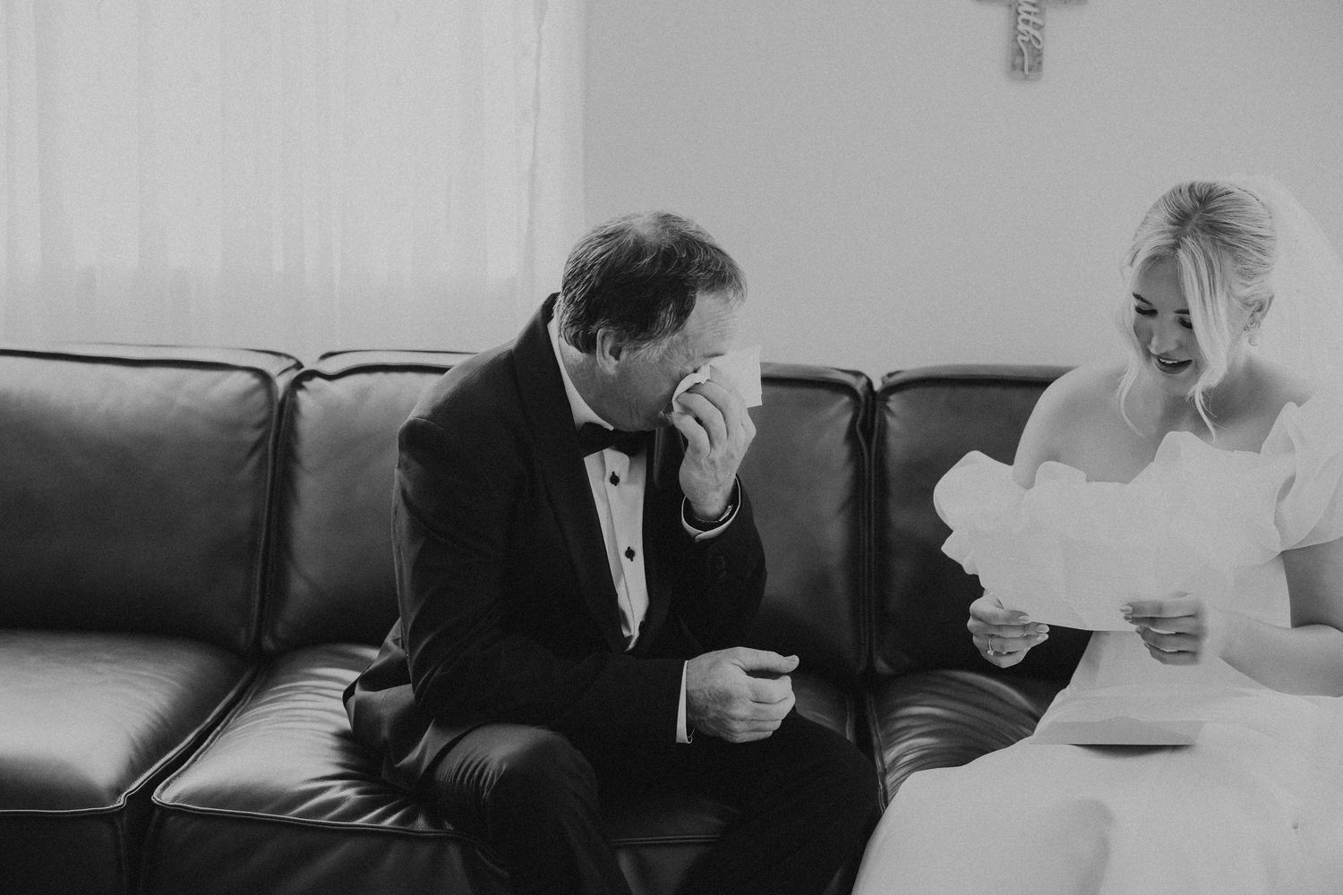 Black and white candid moments during wedding preparations in bright interior.