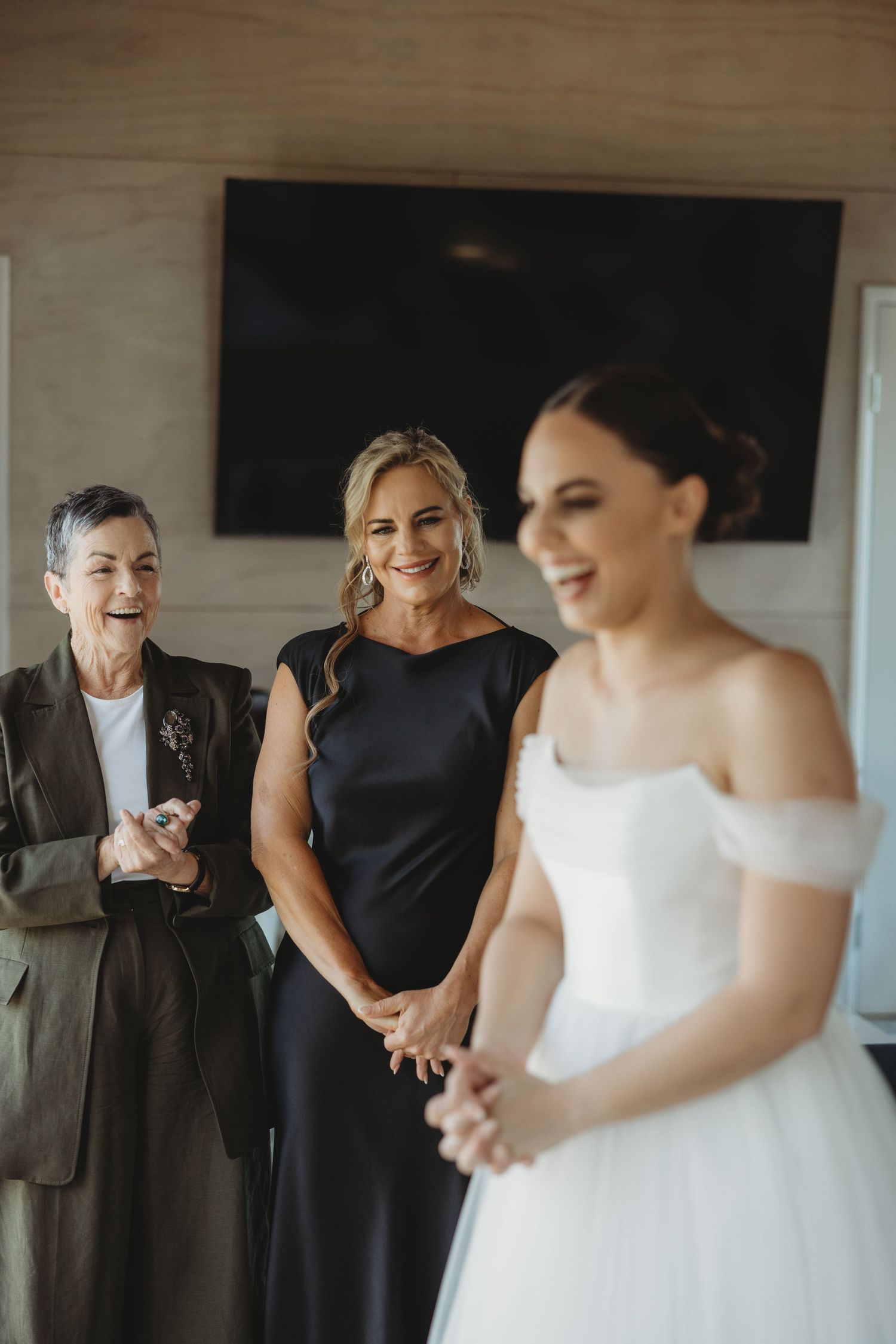 Emotional reactions during a wedding first look moment in a light-filled room.