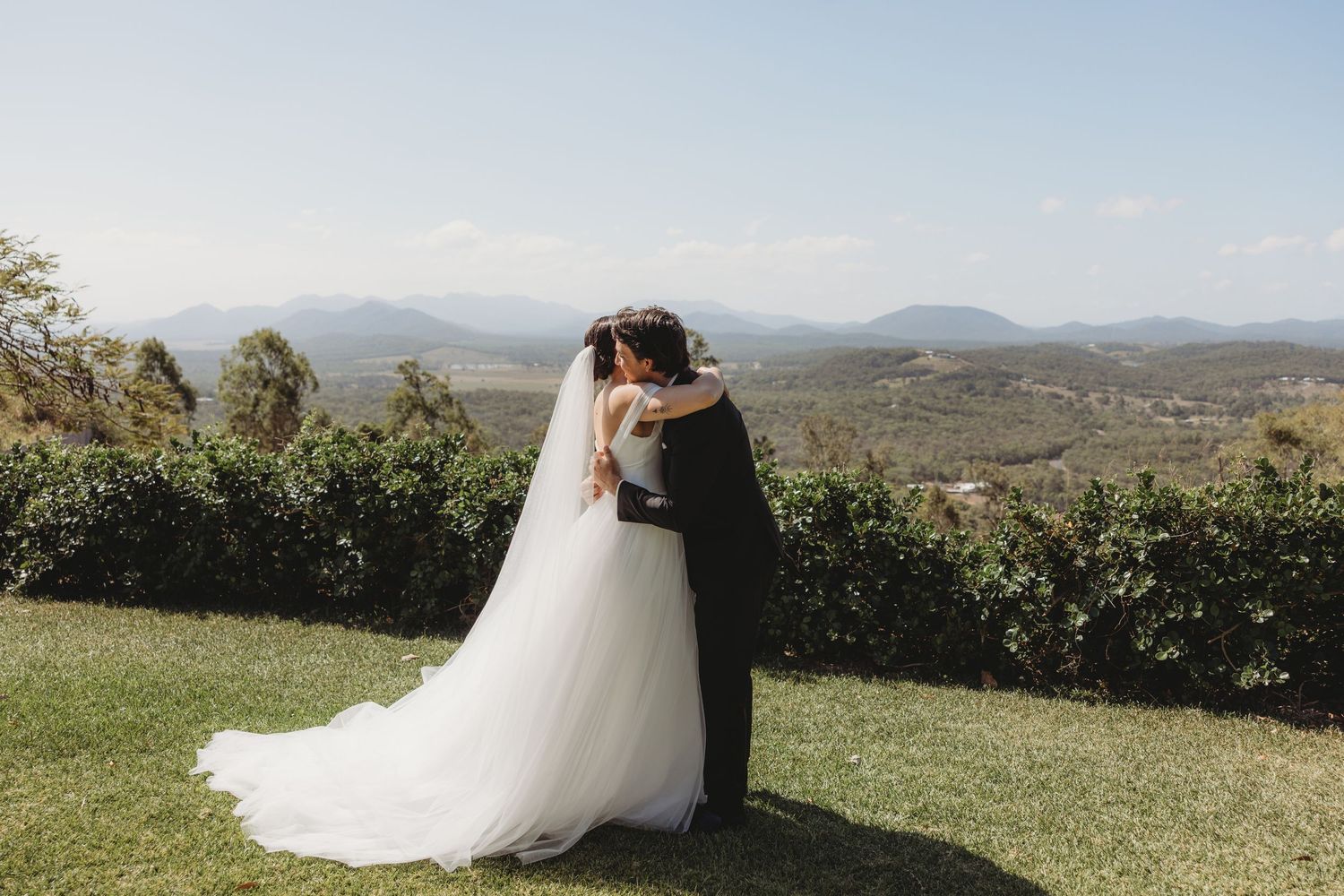 Newlyweds share tender moments during their outdoor mountain wedding photoshoot.