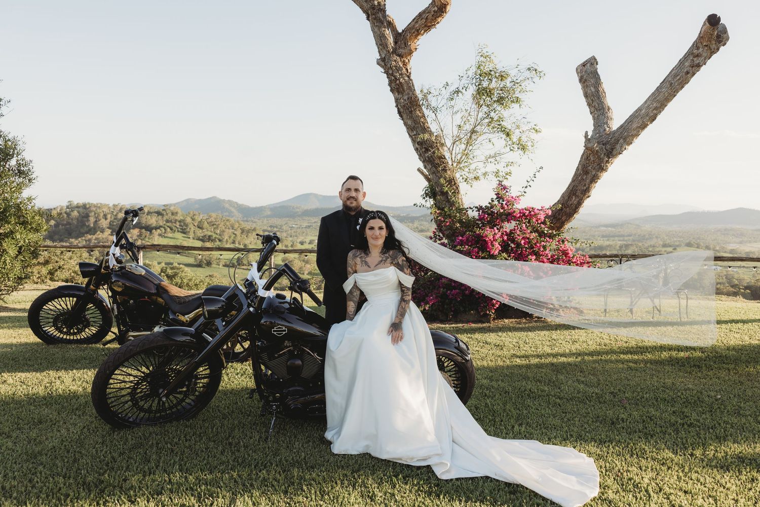 White wedding dress and motorcycle staged against a scenic mountain backdrop.