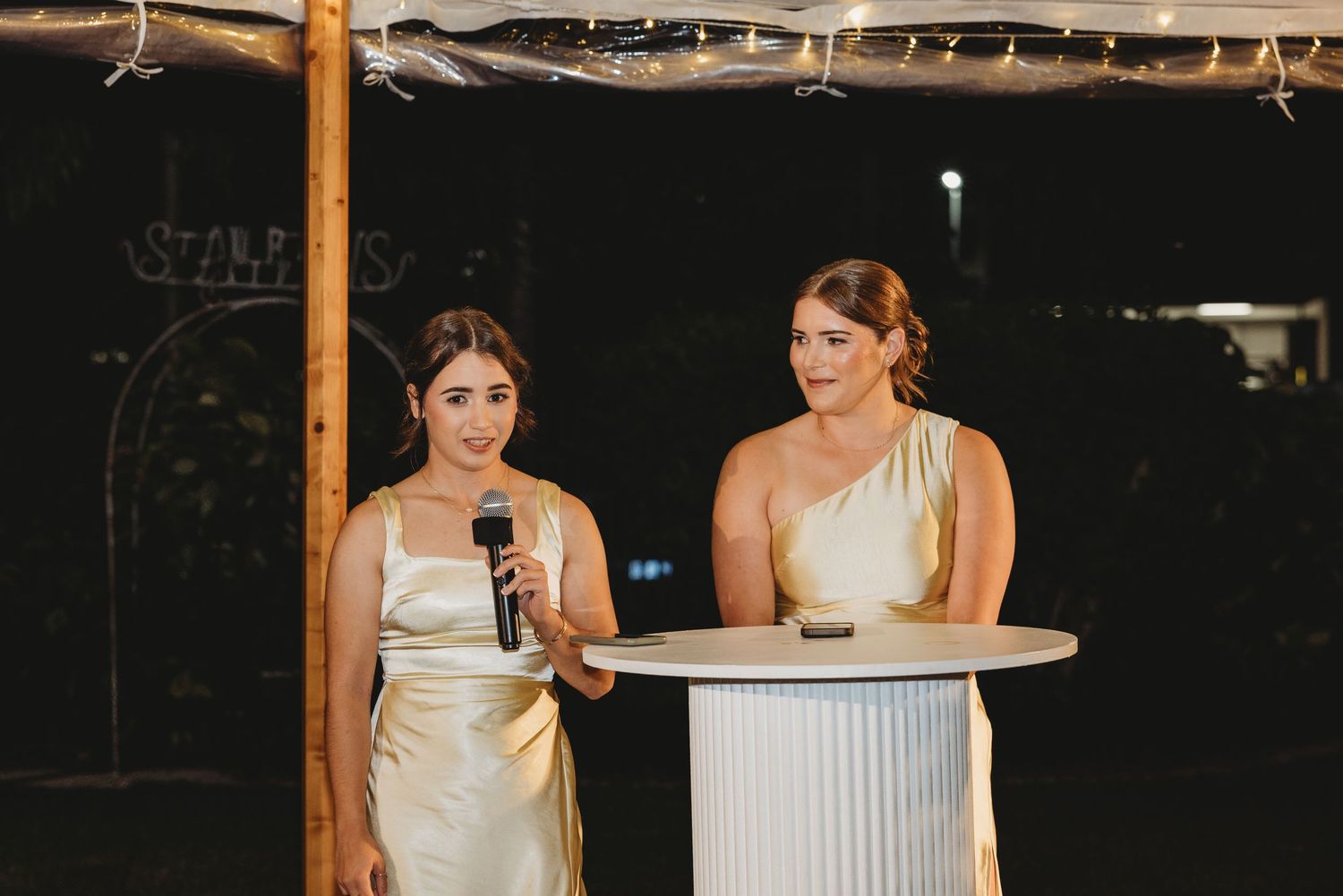 Wedding reception venue with wooden beams and string lights creating a rustic elegant atmosphere. St aubins village