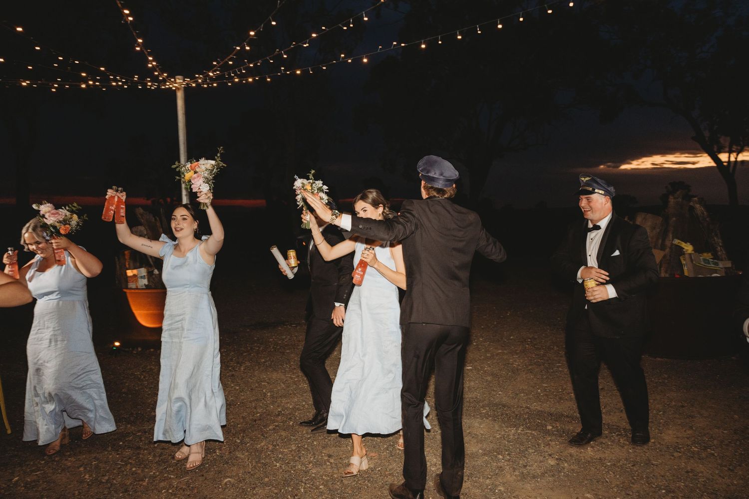 Wedding reception dance floor at night with string lights creating a romantic atmosphere.
