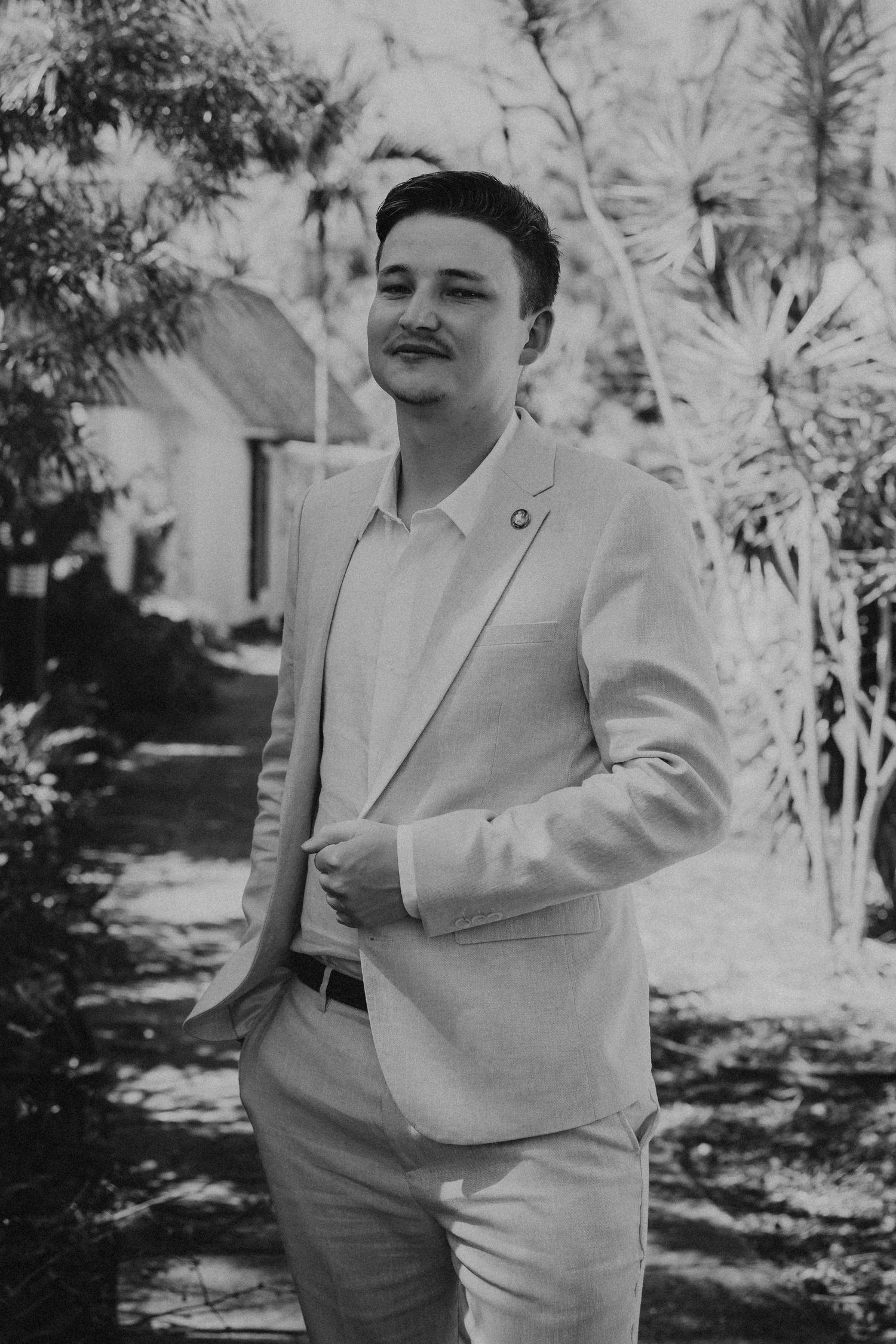Black and white portraits showing joyful expressions in a garden setting.