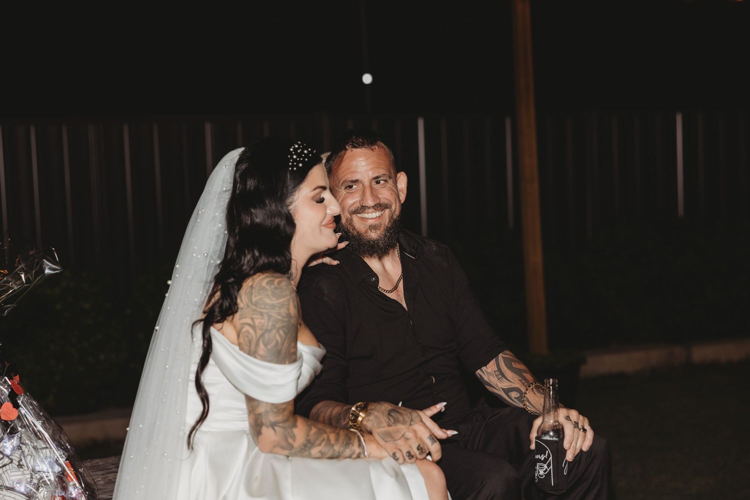 Romantic nighttime portrait of newlyweds sharing joyful moment.