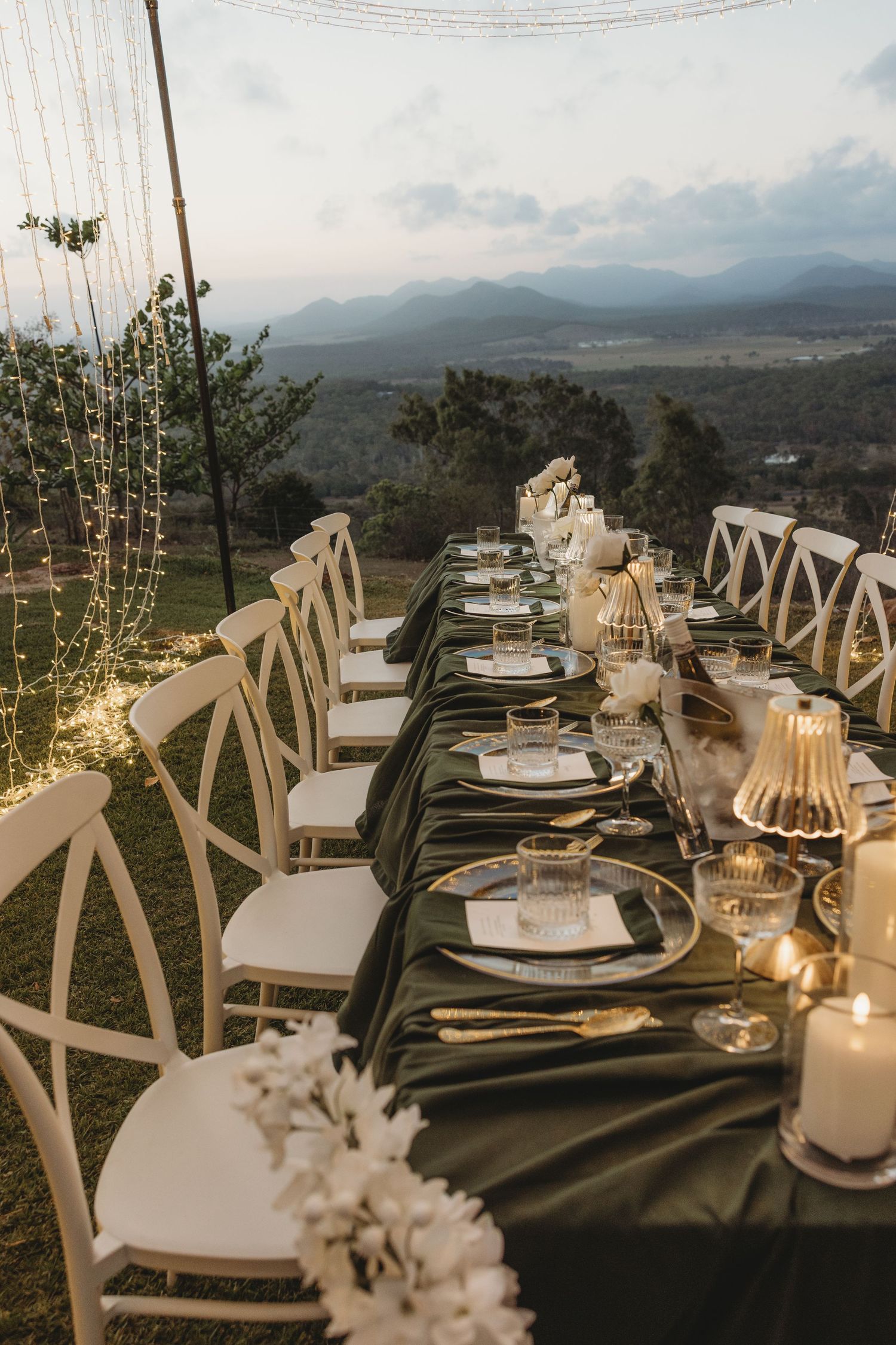 Elegant table settings with mountain views at an outdoor wedding reception.