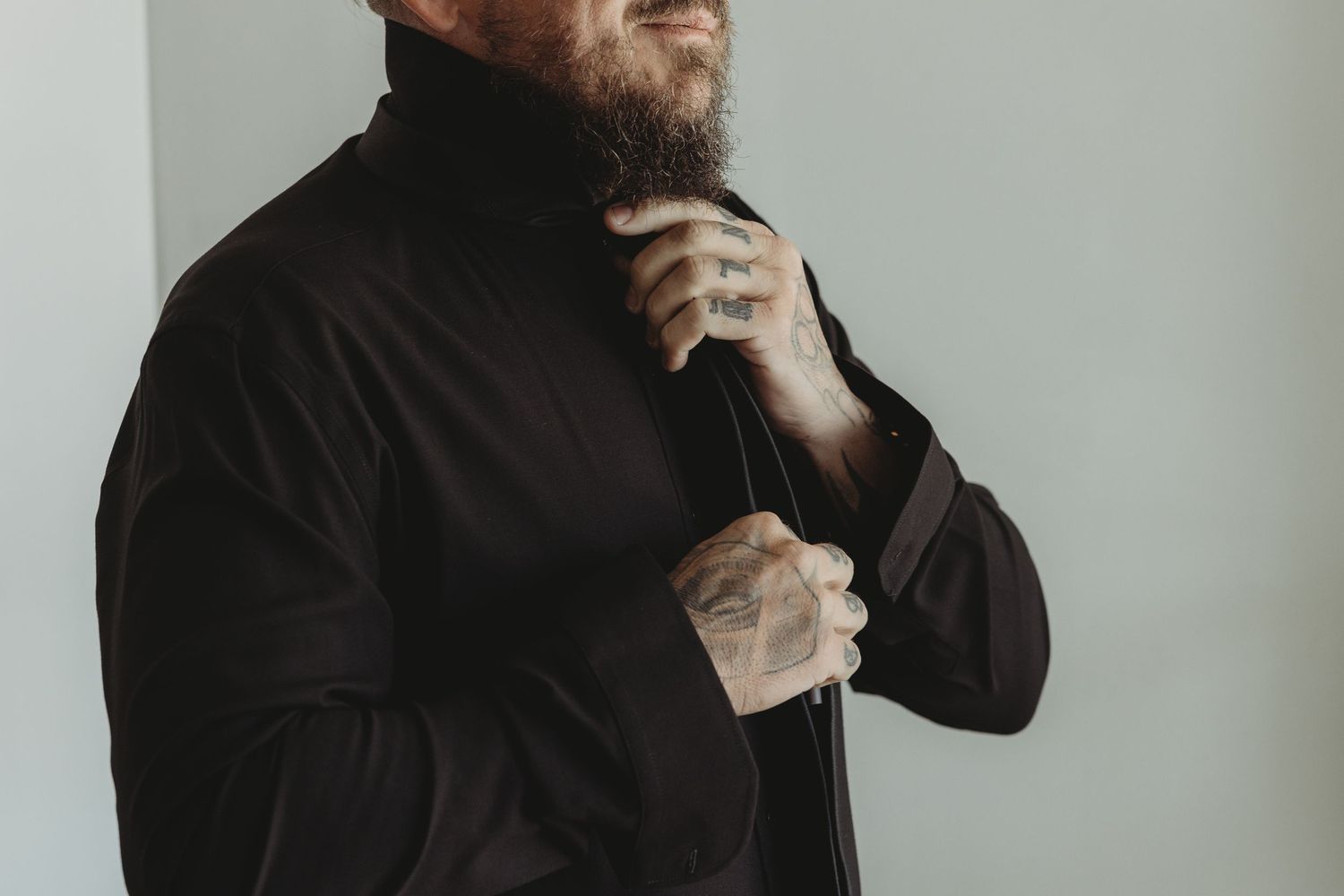 Person in a black turtleneck sweater against a gray background shown from multiple angles.