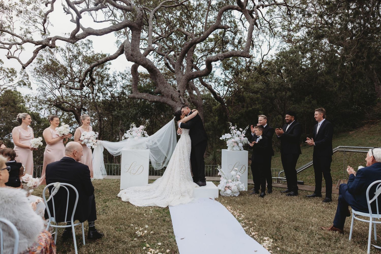 A collage of outdoor wedding ceremony moments with guests and flowing white dresses in a natural setting.