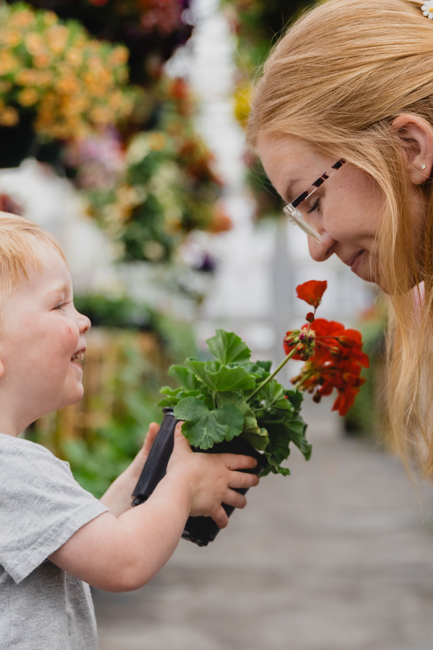 Boy holding flower for mom to smell