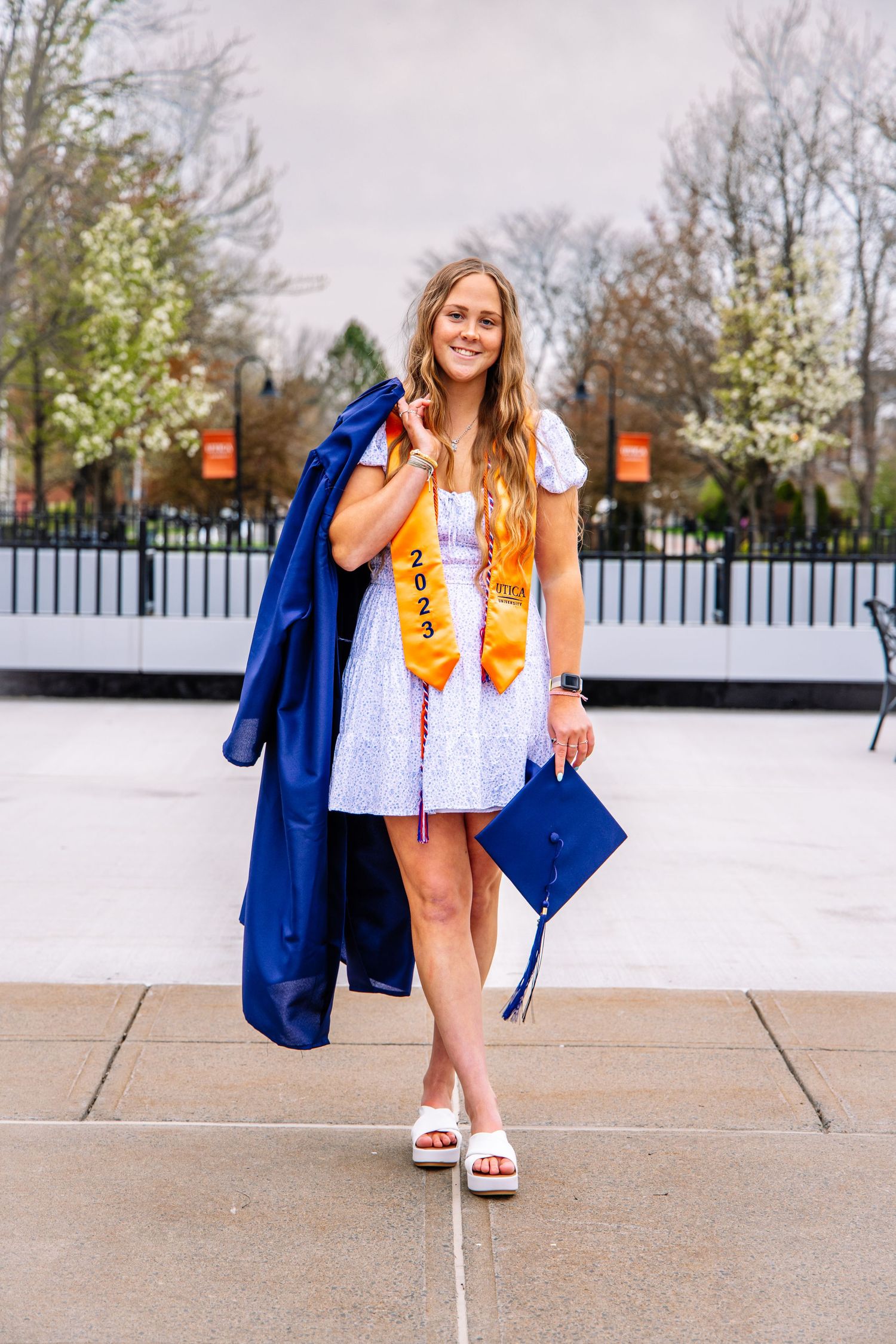 Girl holding graduation cap and gown
