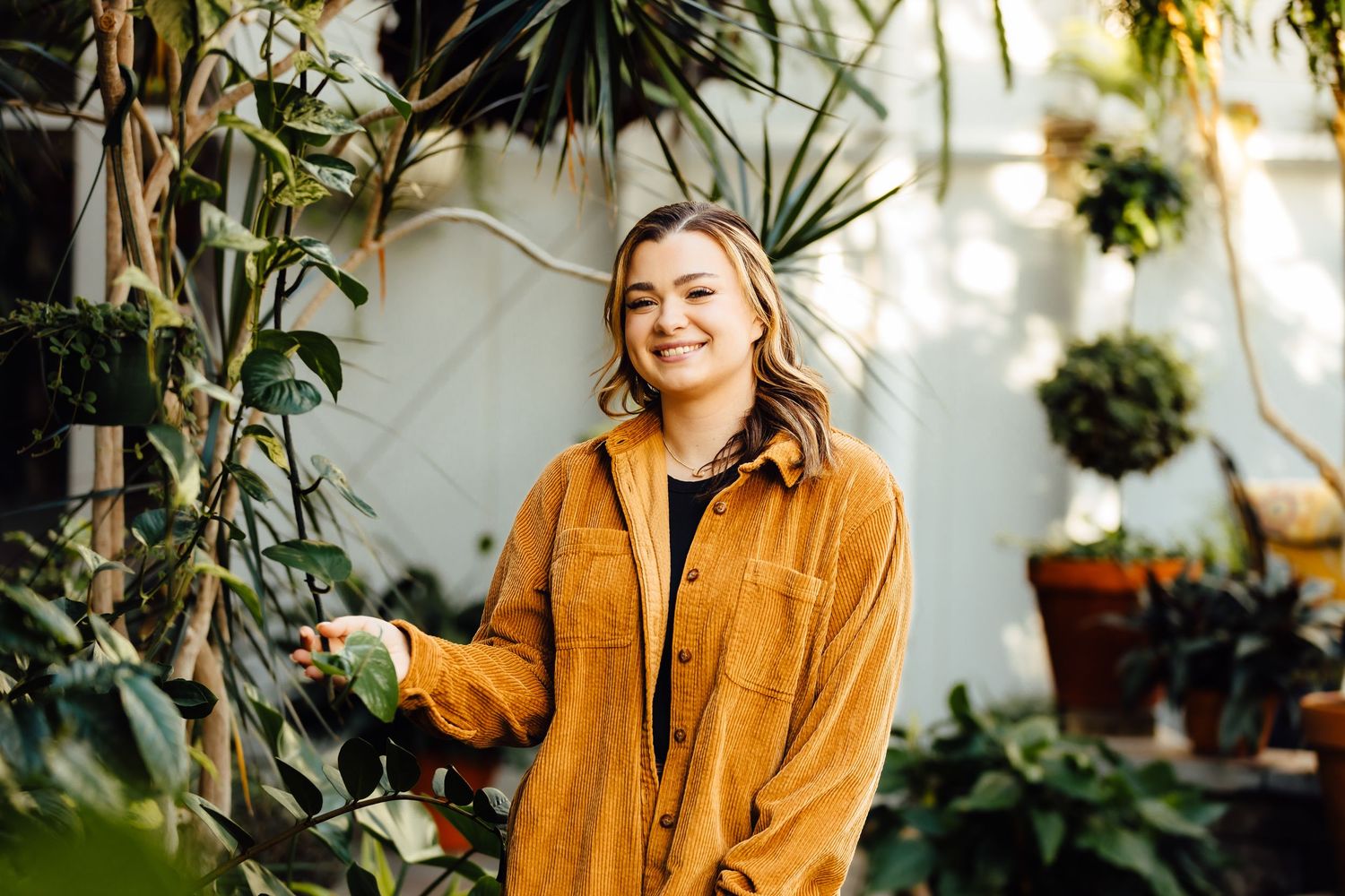 Girl posing in greenhouse