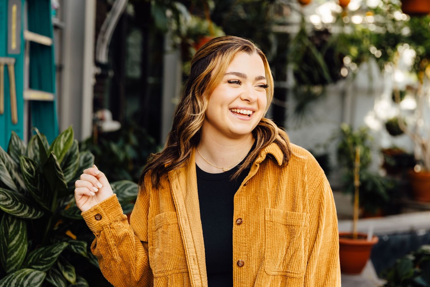 Girl laughing in greenhouse