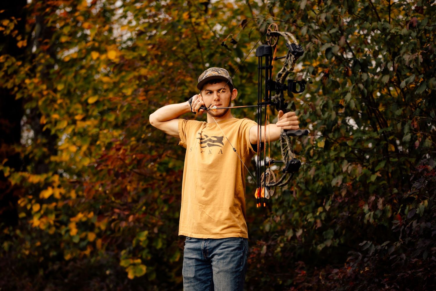 Boy with hunting bow drawn