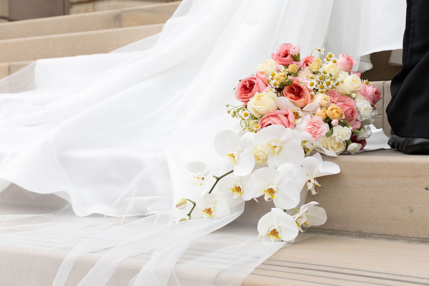 White wedding dress details with delicate floral bouquets in pink and cream tones against a light backdrop.