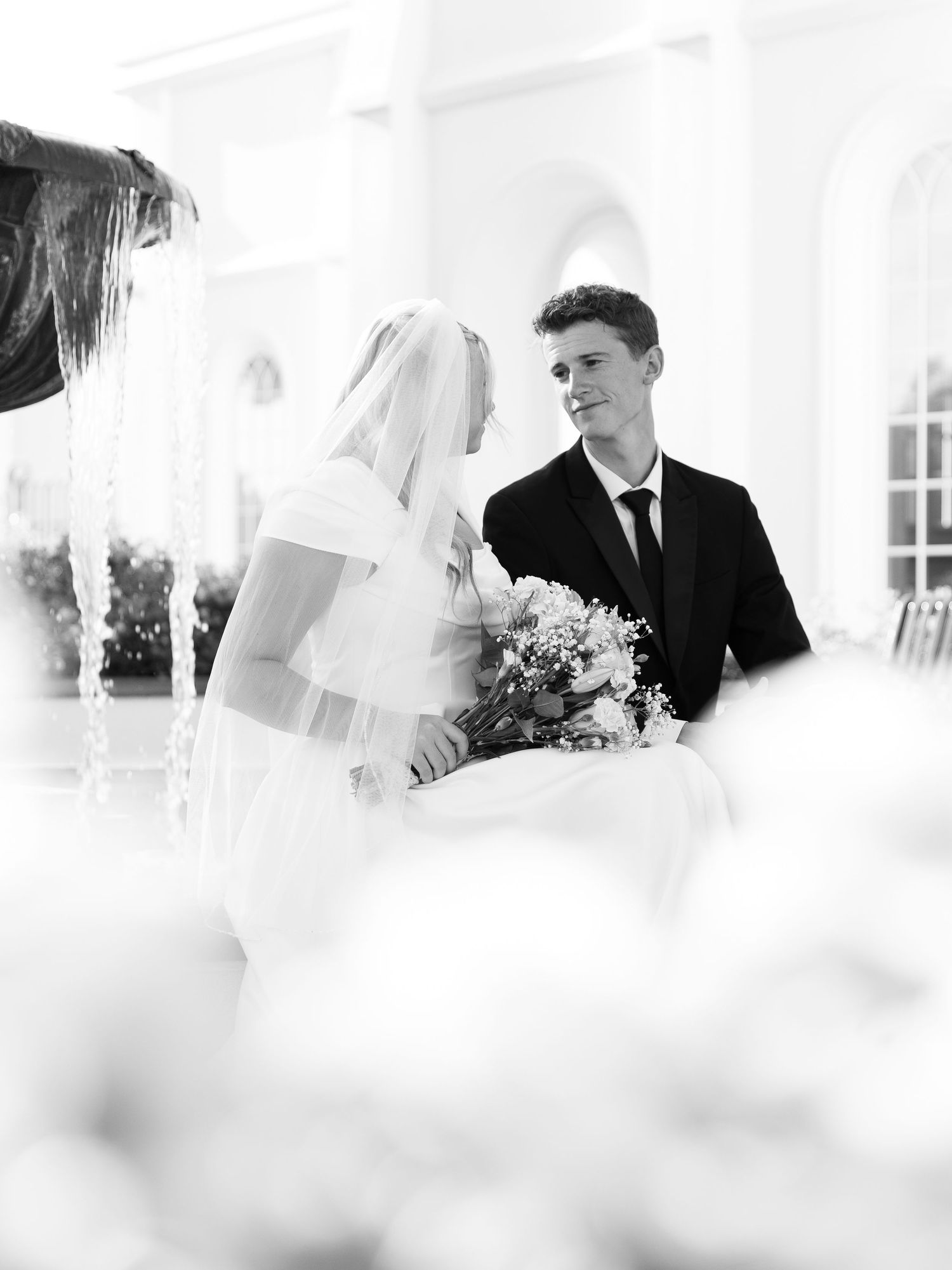 A dreamy black and white wedding photograph through sheer fabric.