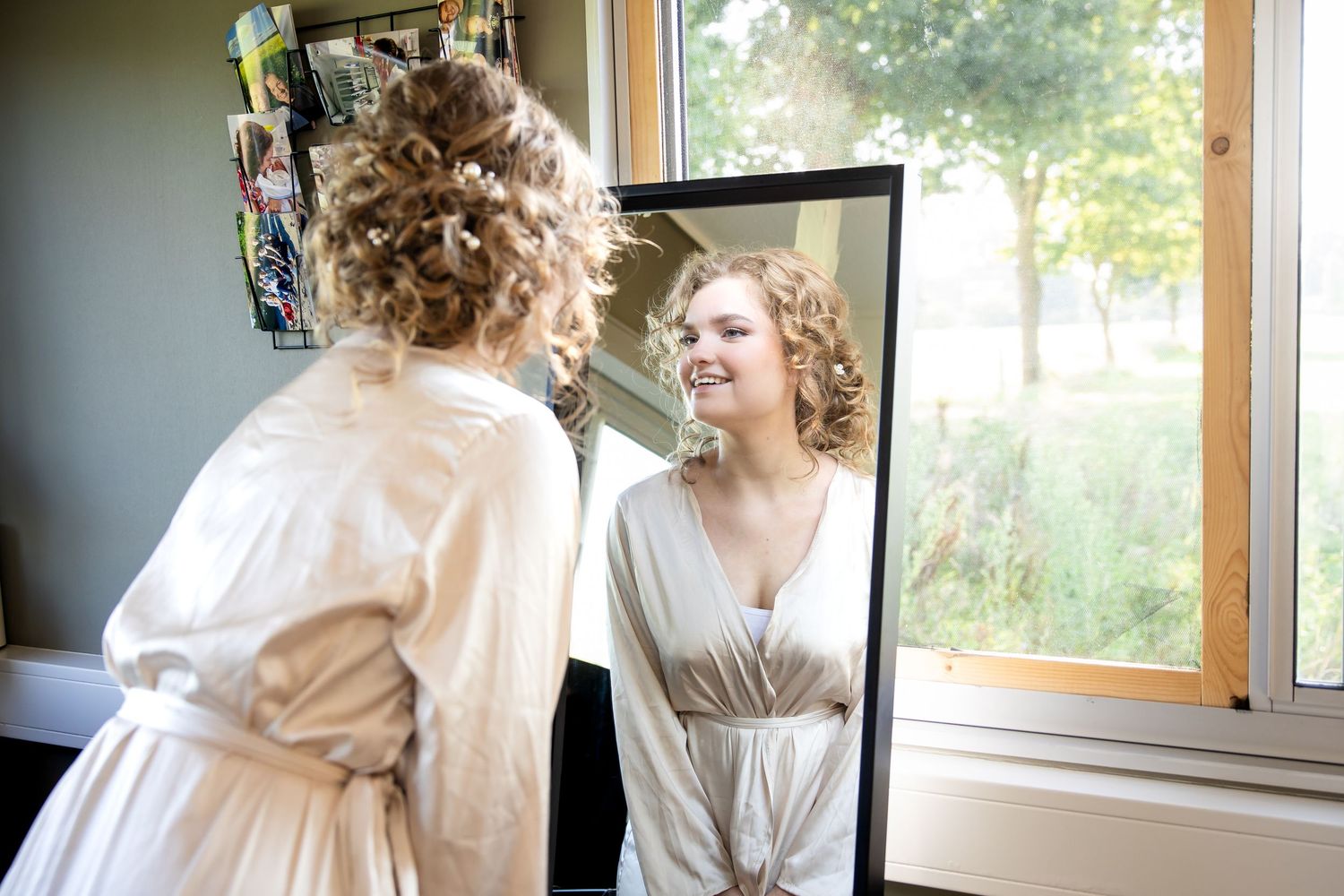 Natural light streams through windows during wedding preparation.