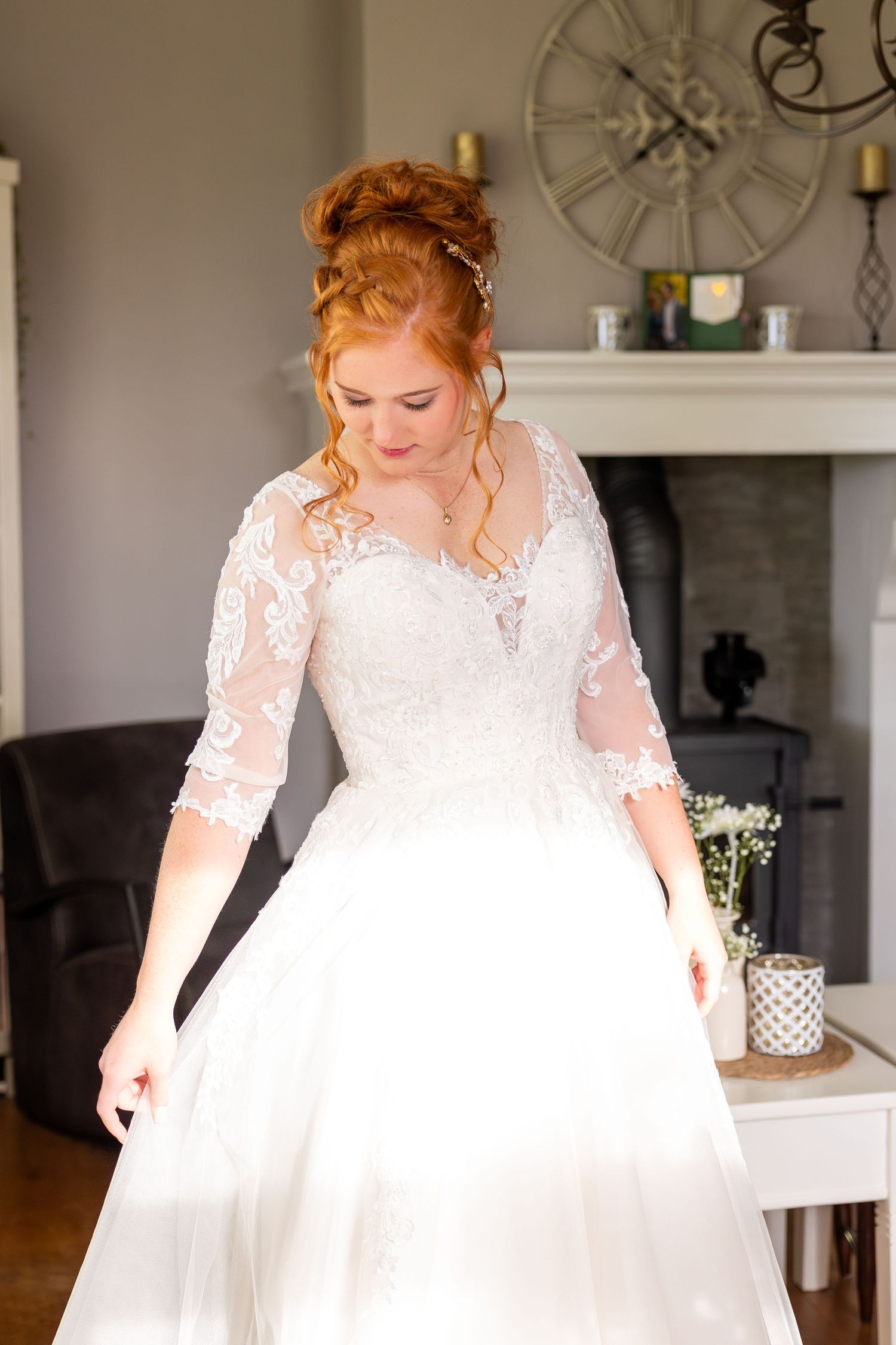 White lace wedding dress details in a bright interior setting with vintage decor.