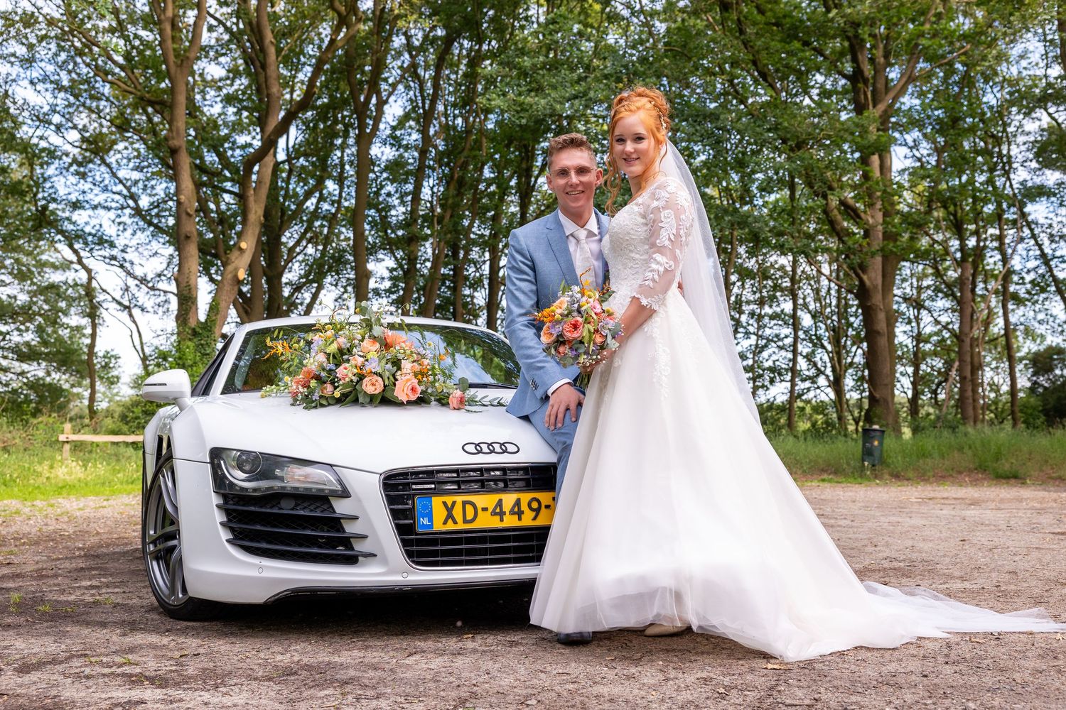 White Audi R8 sports car parked in a scenic outdoor location for wedding photos.